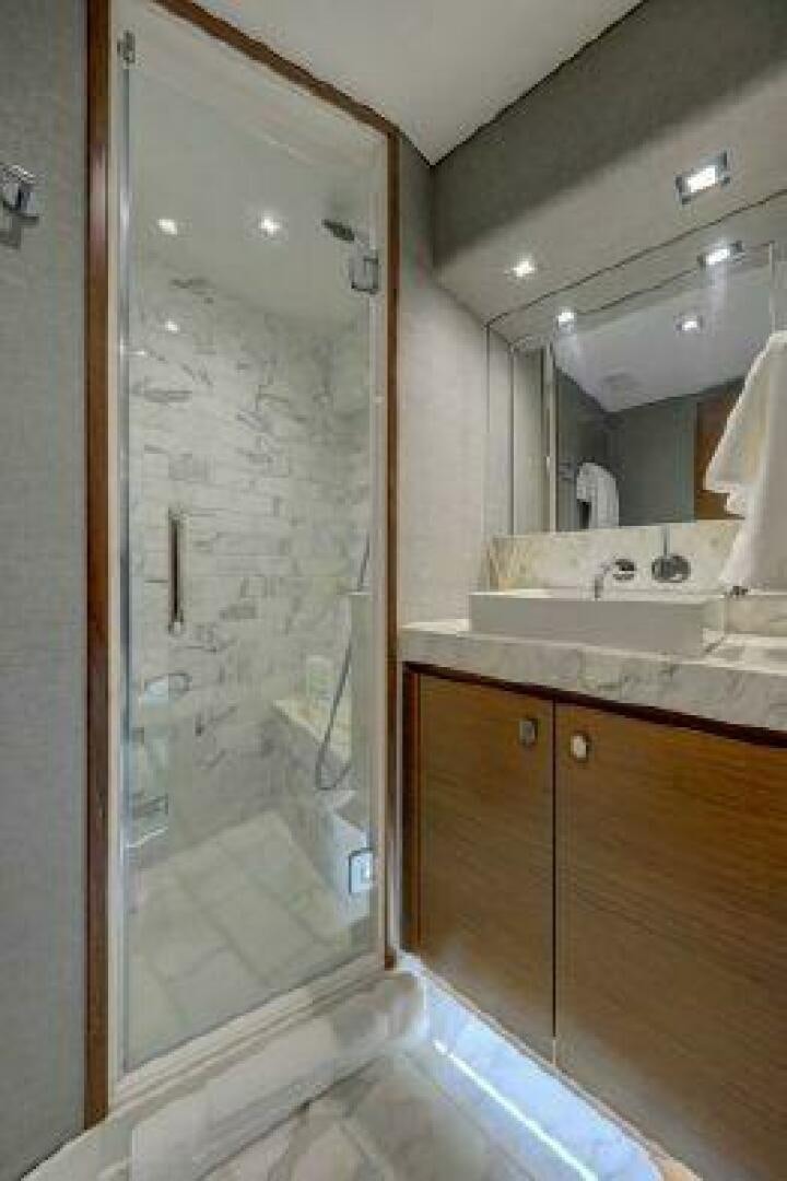 a bathroom with a shower unit and sink aboard 75 HATTERAS M75 / 2020 Yacht for Sale