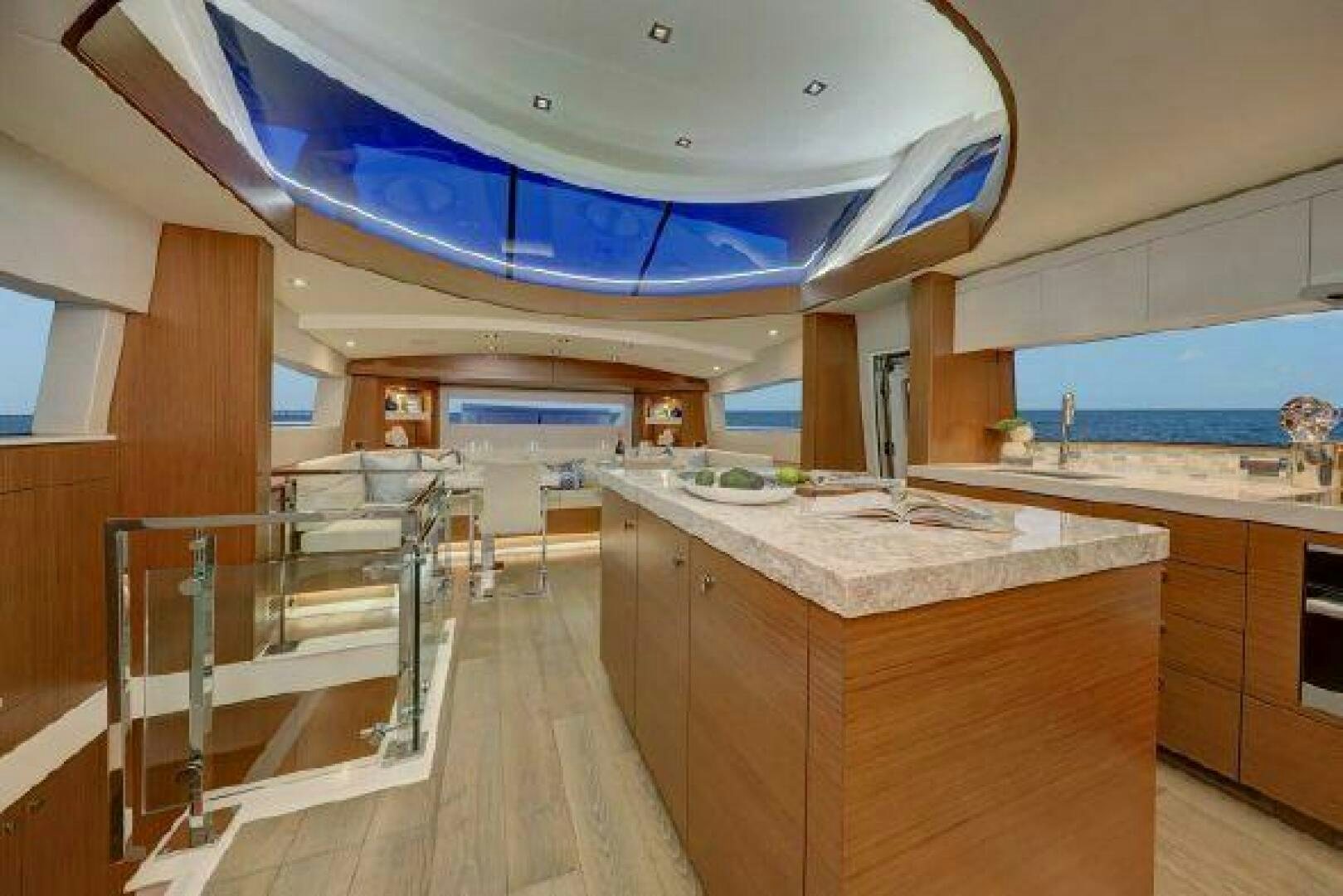 a kitchen with a large island aboard 75 HATTERAS M75 / 2020 Yacht for Sale