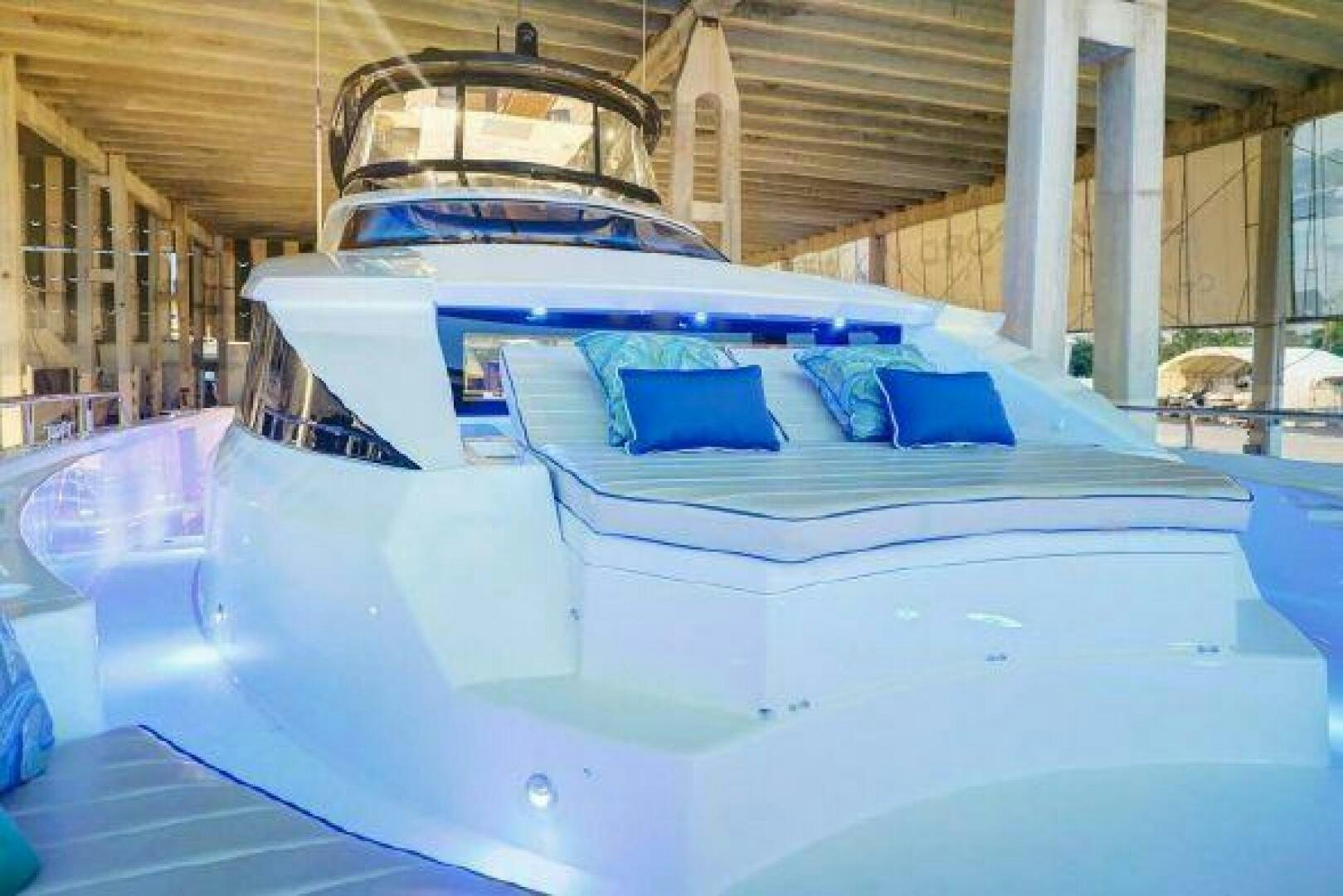 a white boat in a building aboard 75 HATTERAS M75 / 2020 Yacht for Sale