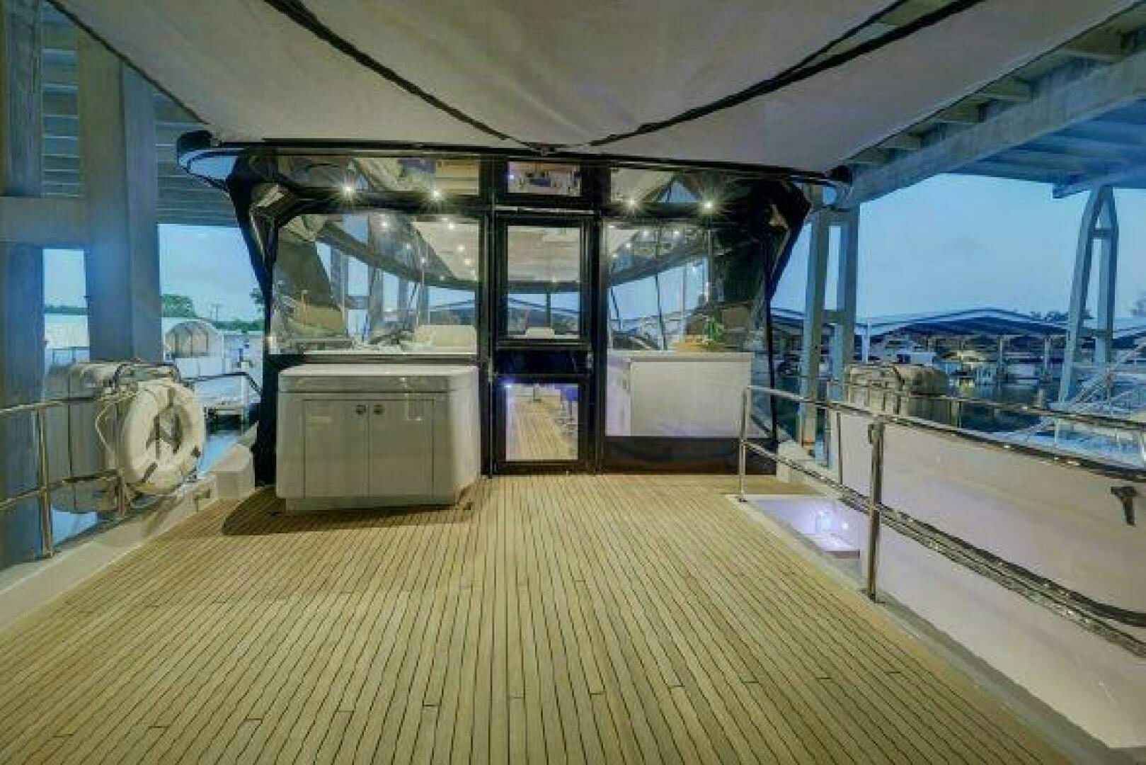 a large room with a wood floor and a large window aboard 75 HATTERAS M75 / 2020 Yacht for Sale