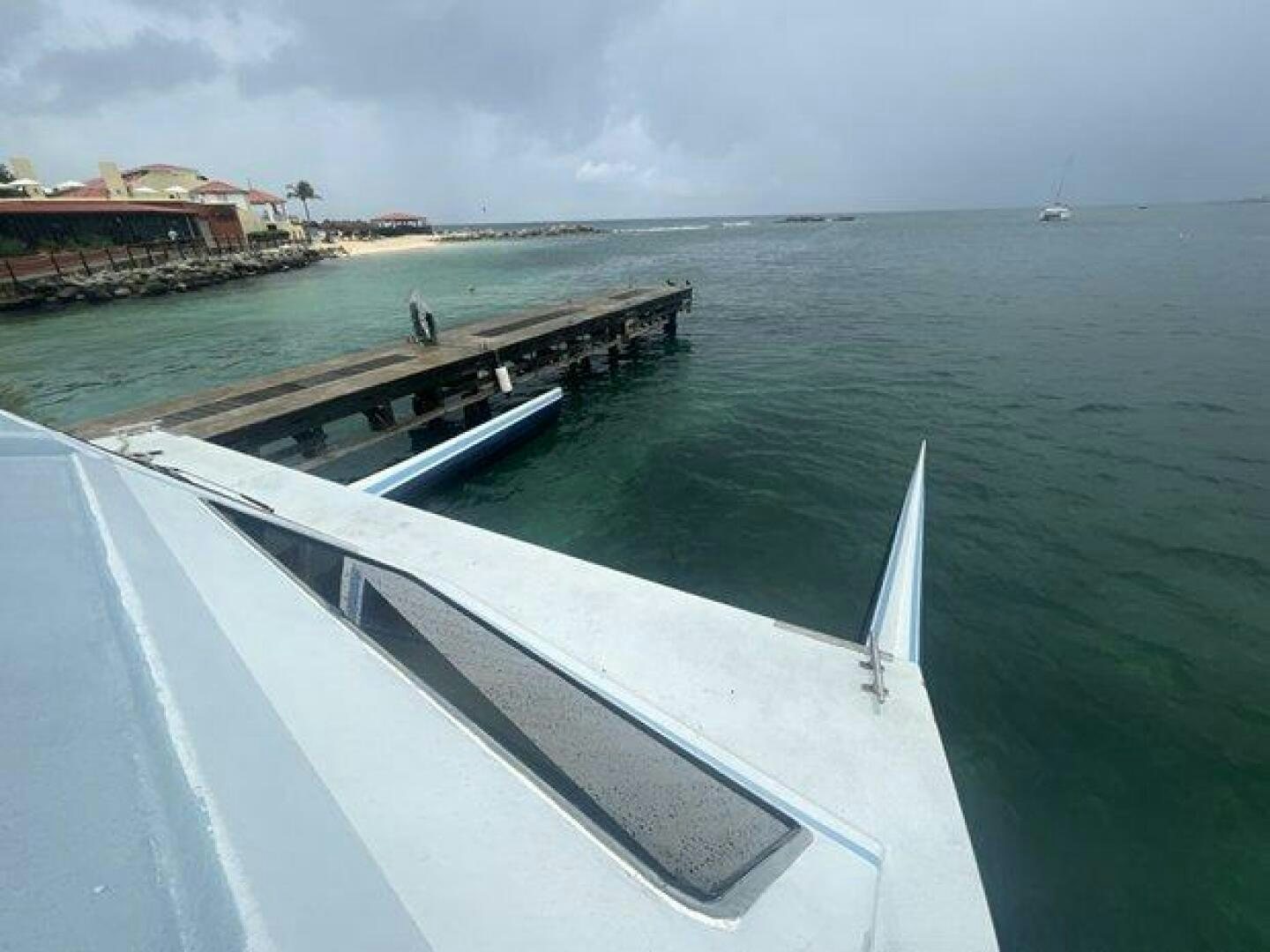 a white boat on the water aboard EDGE 2 Yacht for Sale