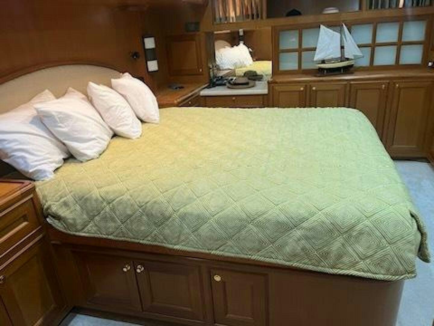 a bed with white sheets aboard MOODY BLUE Yacht for Sale