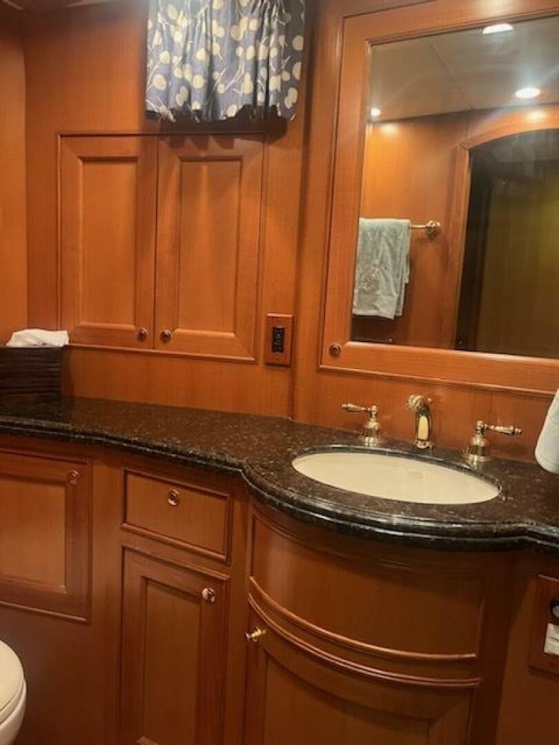 a bathroom with a sink and a mirror aboard MOODY BLUE Yacht for Sale