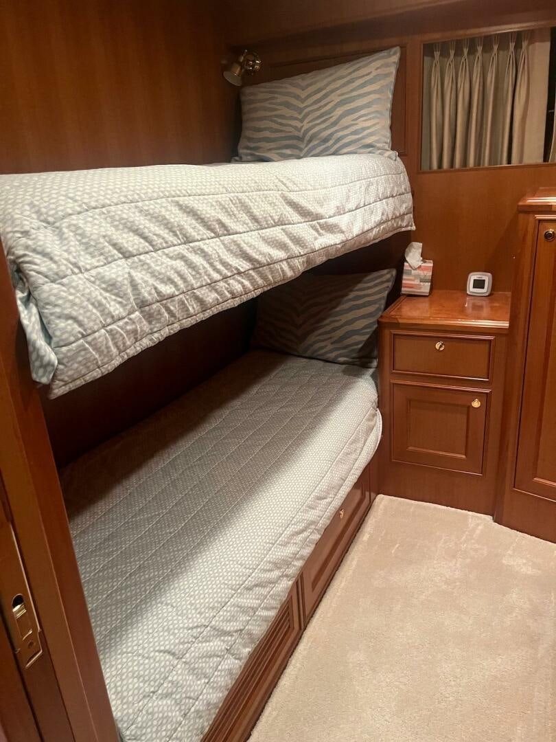 a bed with a white comforter aboard MOODY BLUE Yacht for Sale