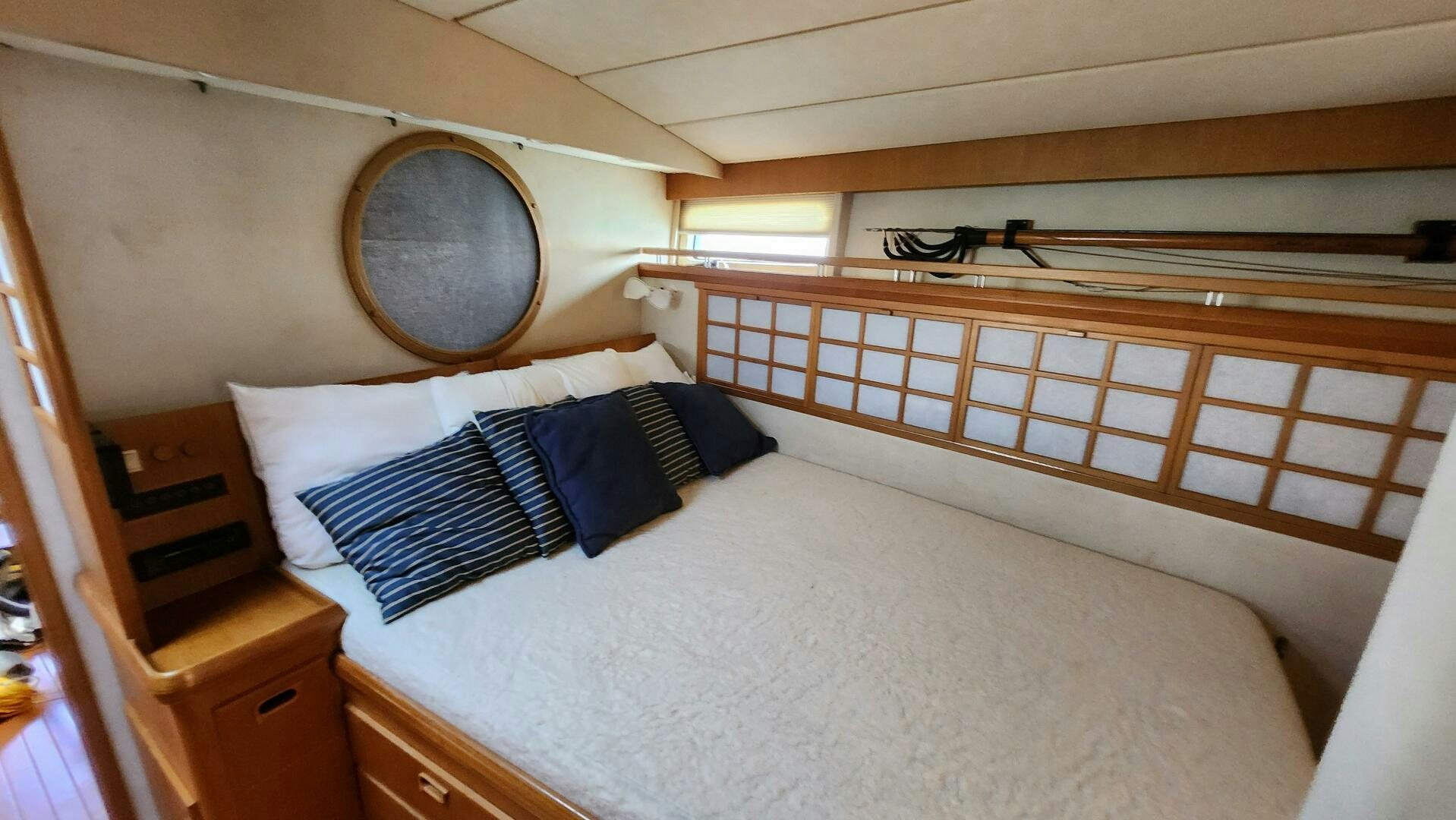 a bed with a round mirror aboard MAYA Yacht for Sale
