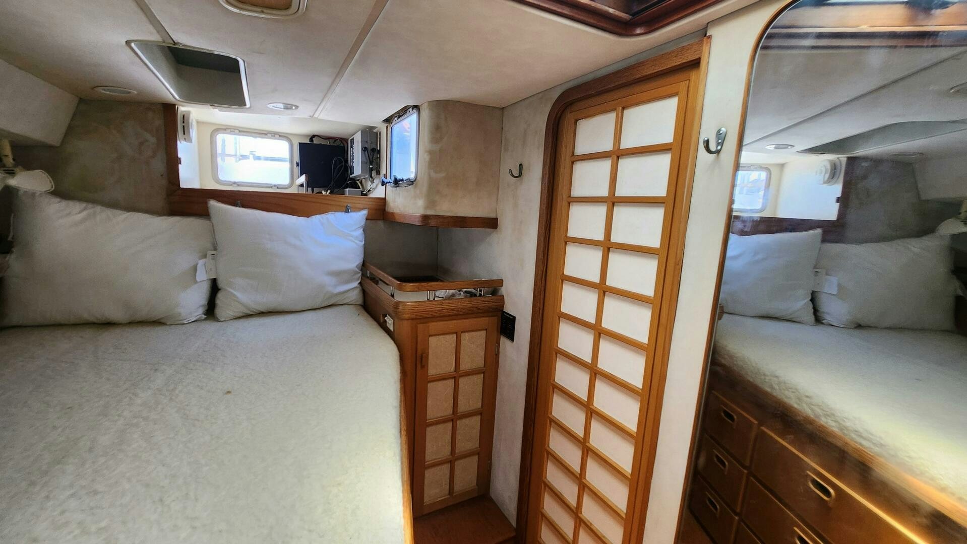 a room with a bed and a desk aboard MAYA Yacht for Sale