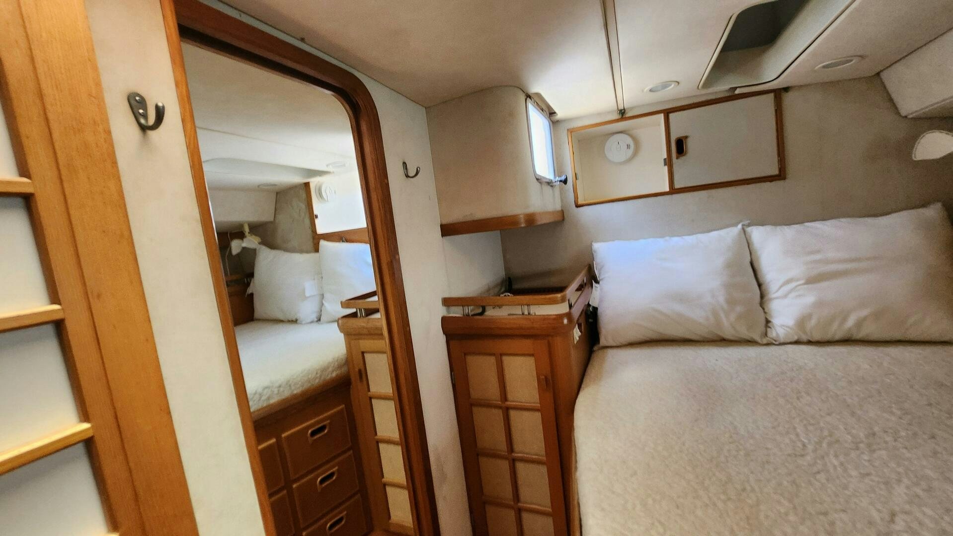 a room with a bed and a dresser aboard MAYA Yacht for Sale