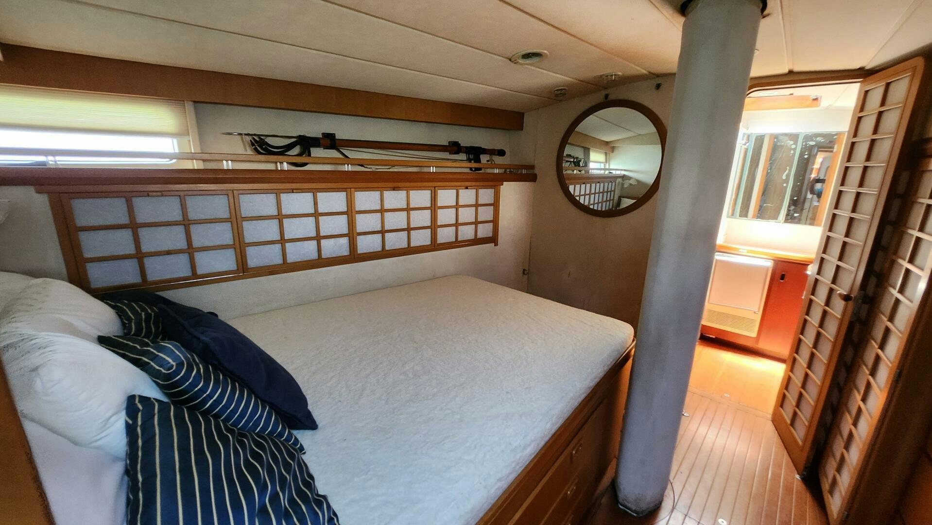 a bedroom with a bed and a mirror aboard MAYA Yacht for Sale
