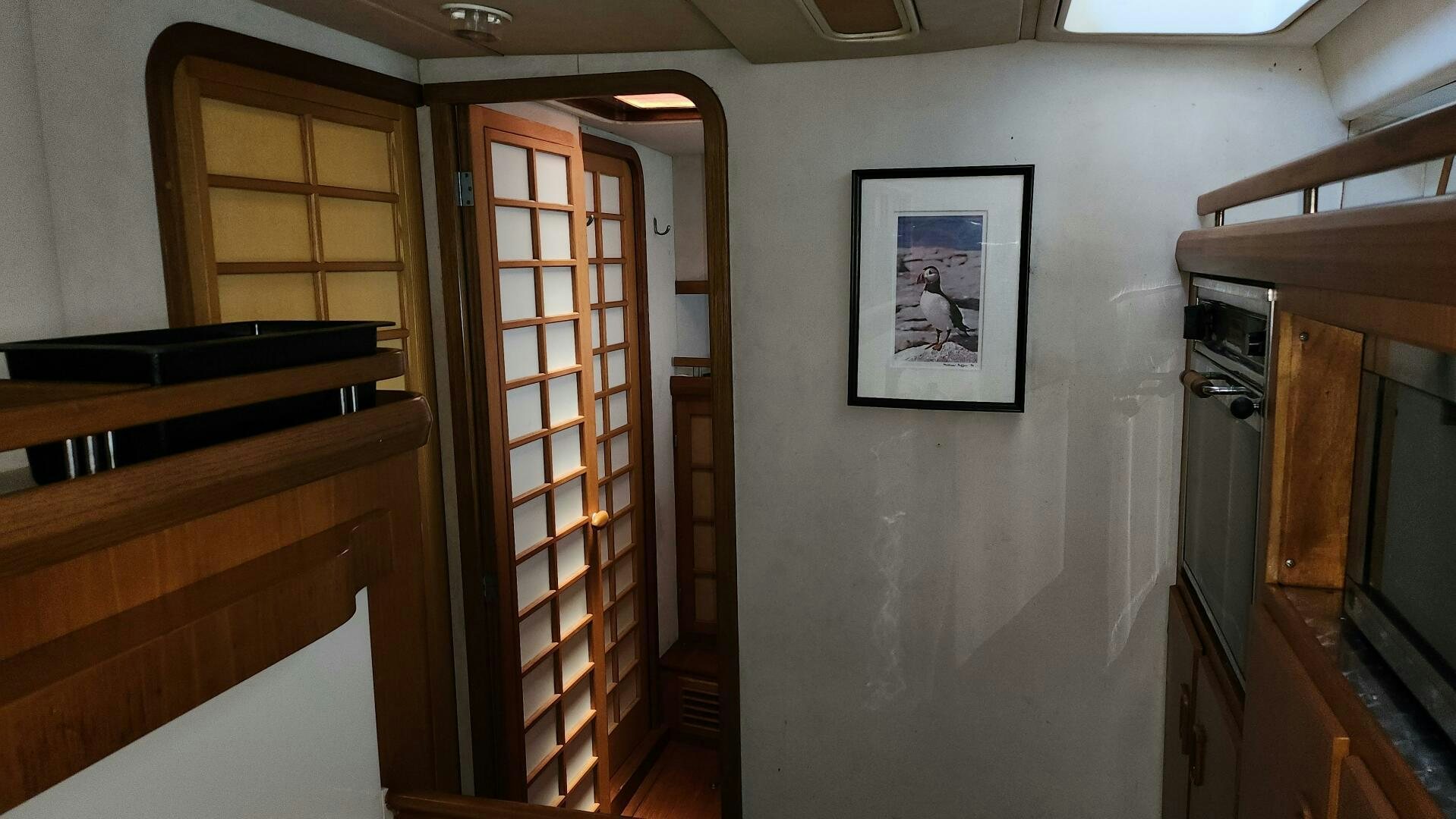 a room with a door and pictures on the wall aboard MAYA Yacht for Sale