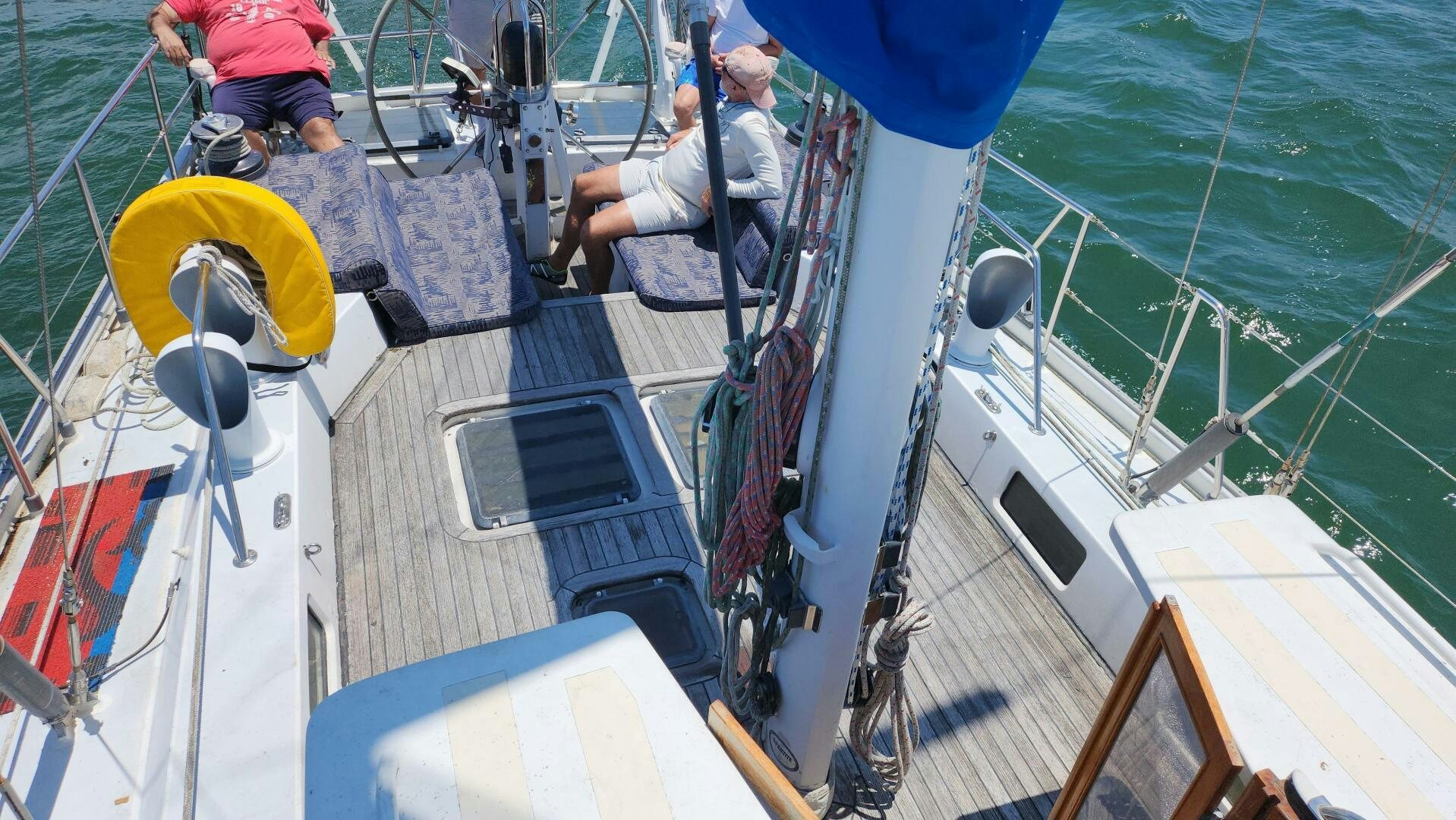 a boat with a yellow and blue sail aboard MAYA Yacht for Sale
