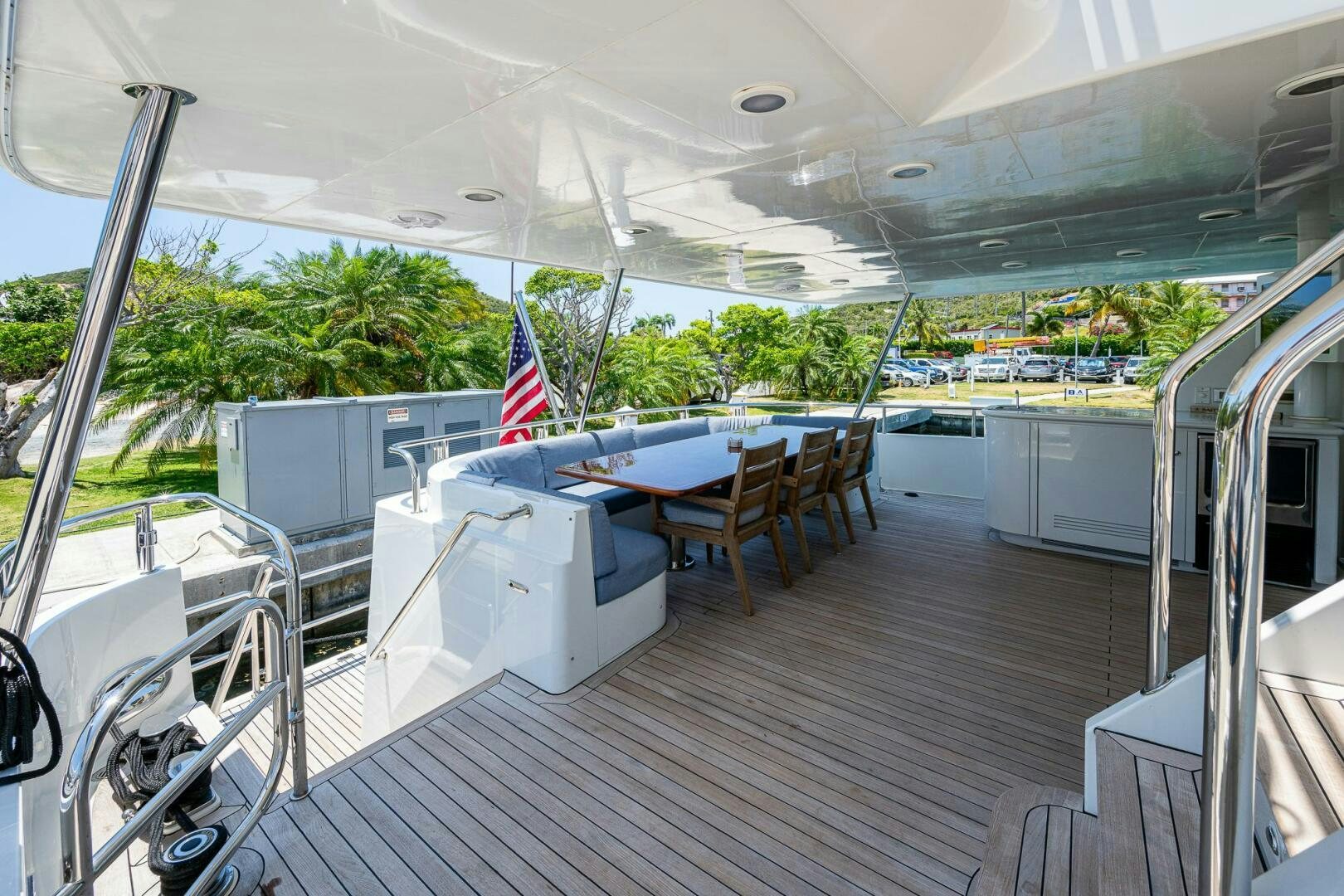 a deck with a table and chairs aboard LADY LORRAINE Yacht for Sale