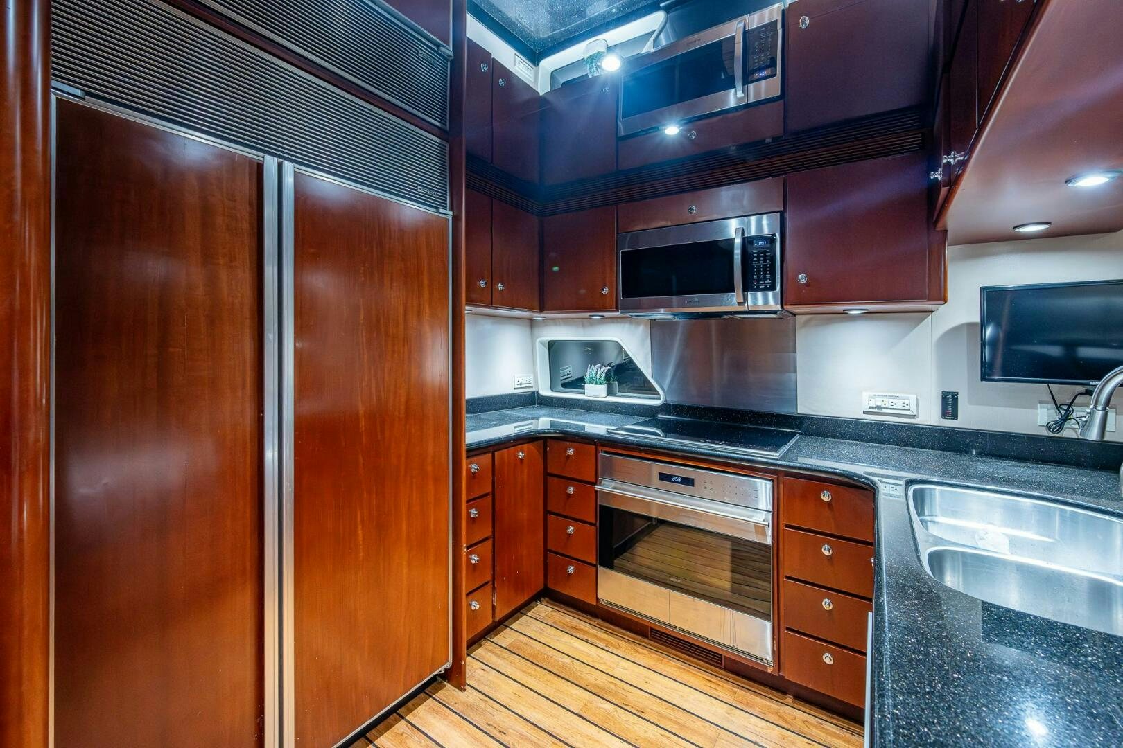 a kitchen with wooden cabinets aboard LADY LORRAINE Yacht for Sale