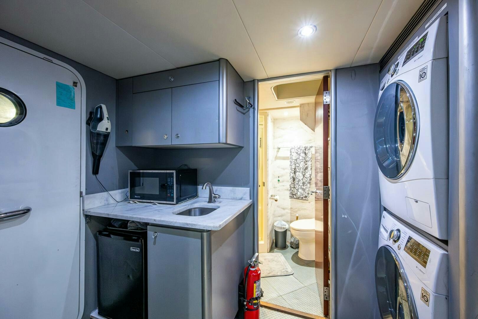 a small kitchen with a washing machine aboard LADY LORRAINE Yacht for Sale