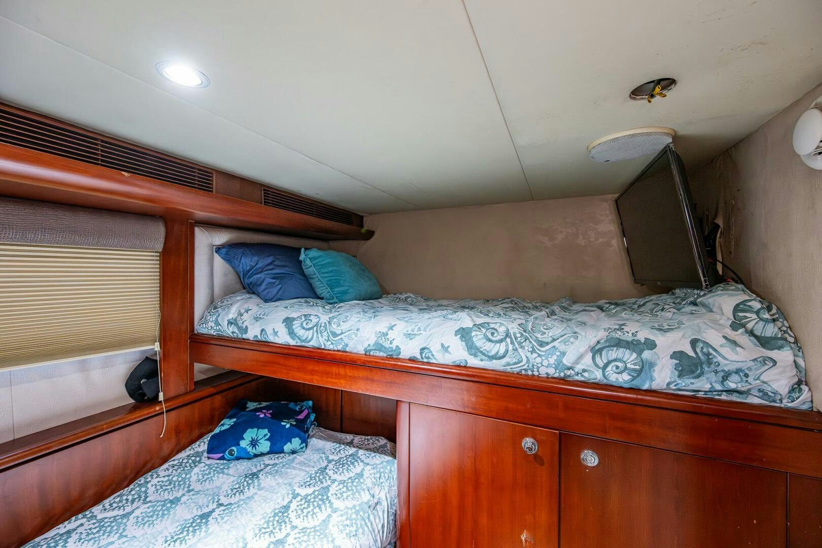 a bed with a blue blanket aboard LADY LORRAINE Yacht for Sale