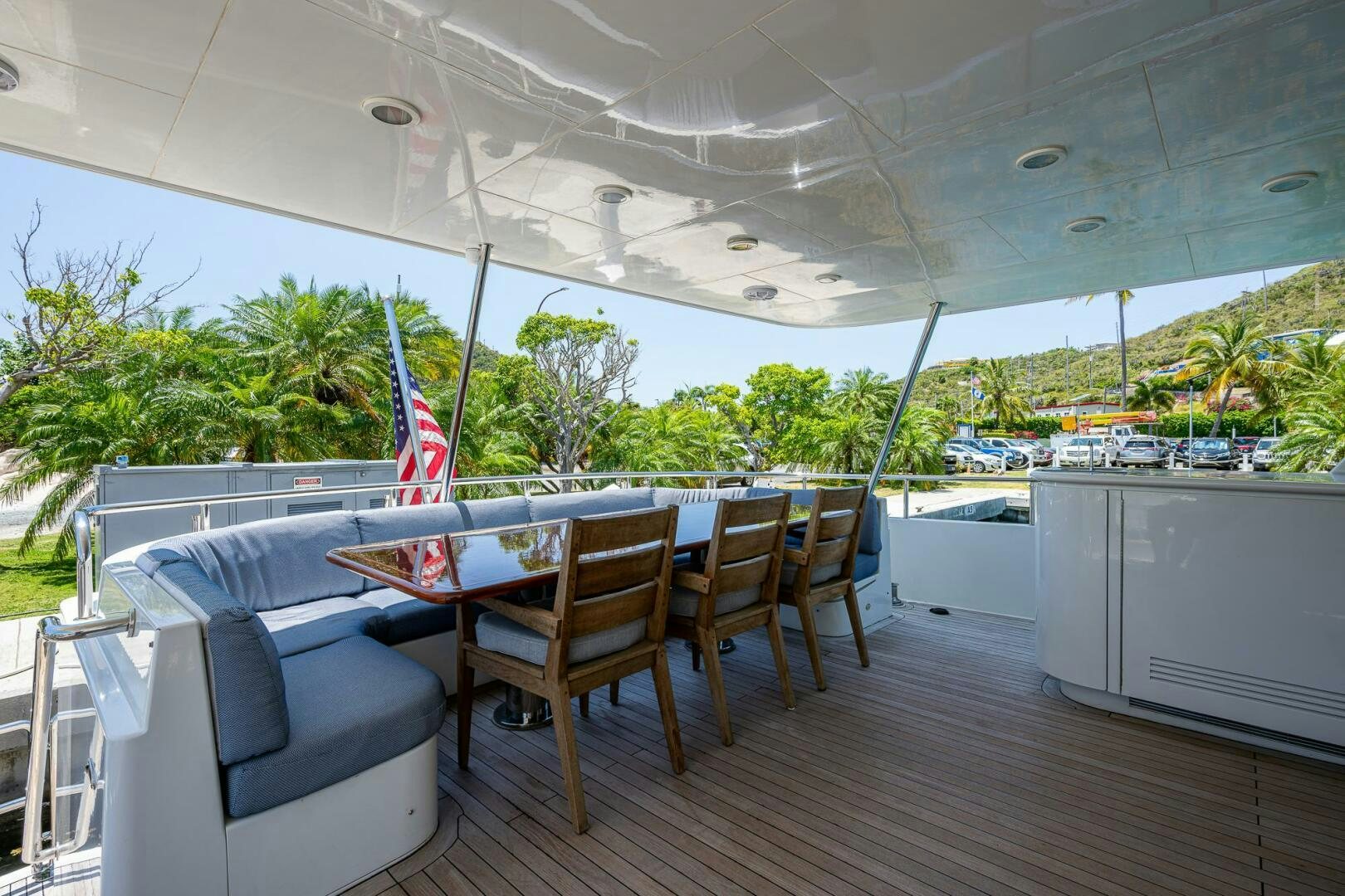 a deck with a table and chairs aboard LADY LORRAINE Yacht for Sale
