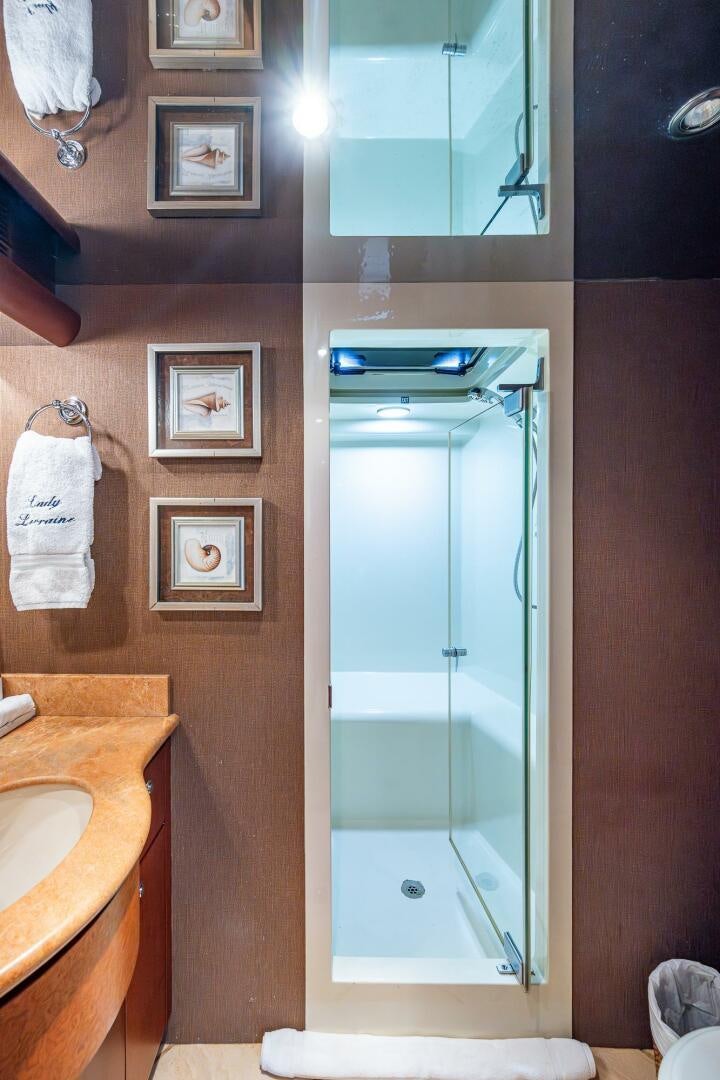 a bathroom with a glass shower aboard LADY LORRAINE Yacht for Sale