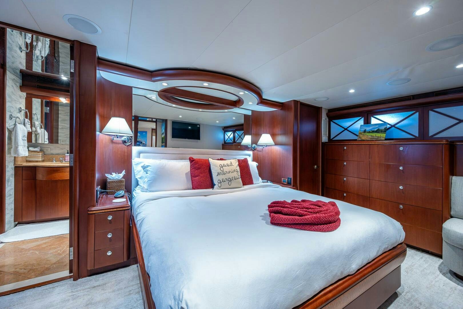 a bedroom with a bed and a mirror aboard LADY LORRAINE Yacht for Sale