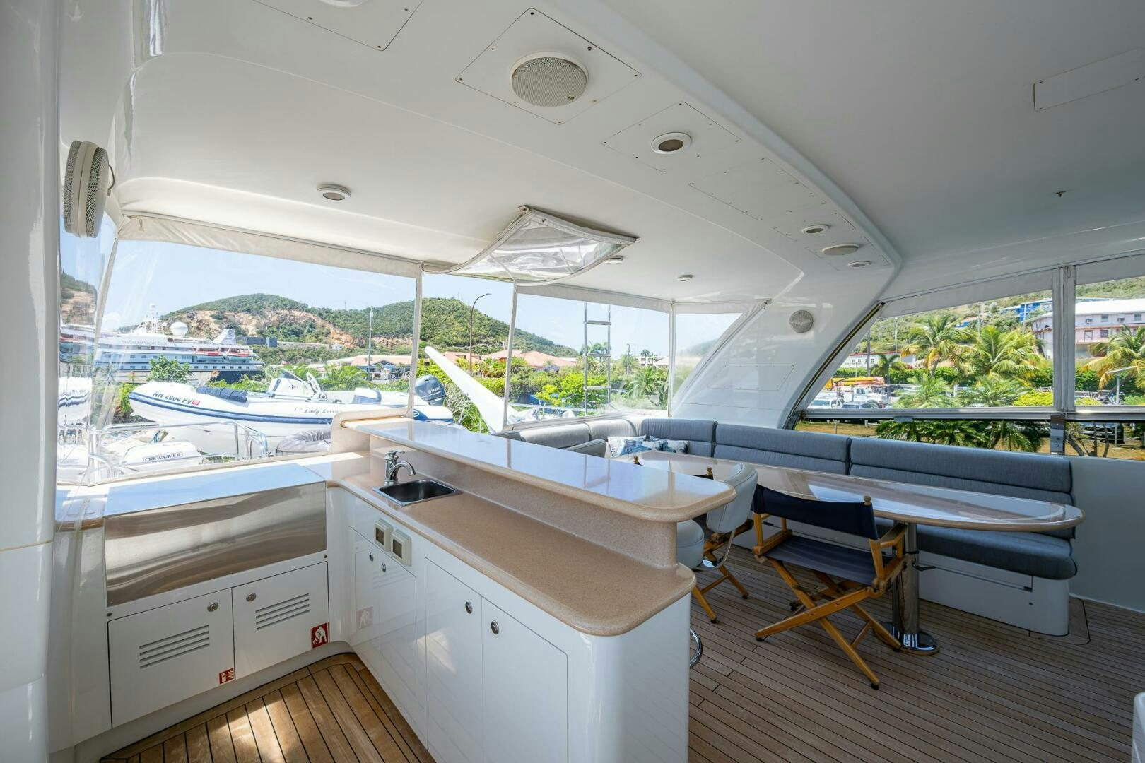a room with a large window and a table with chairs aboard LADY LORRAINE Yacht for Sale
