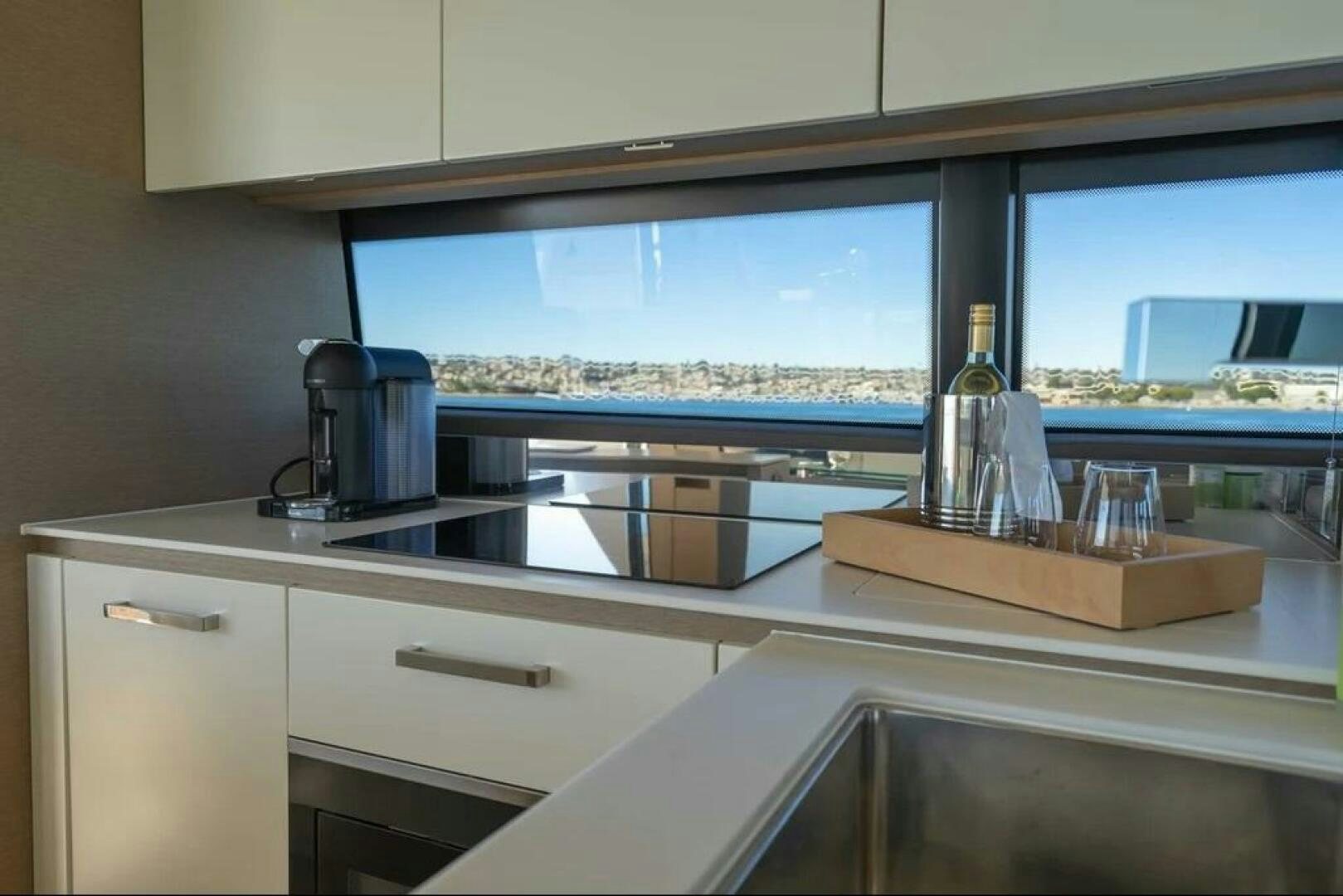 a kitchen with a large window aboard 5 STAR Yacht for Sale