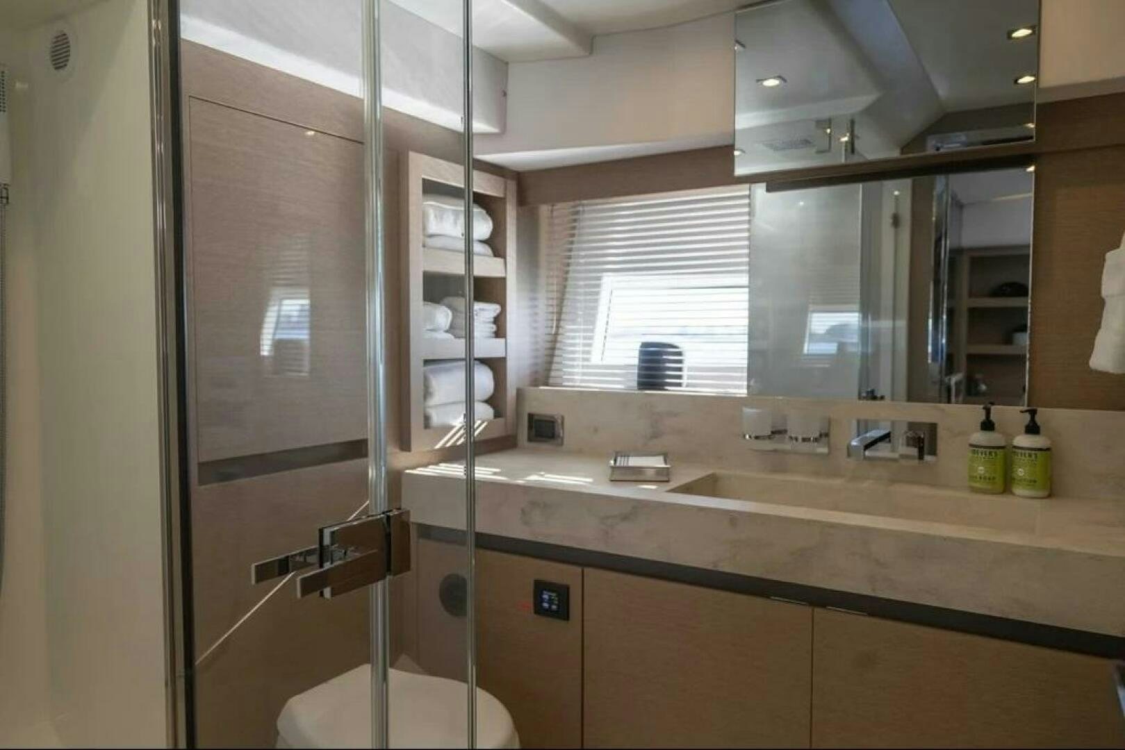 a bathroom with a glass shower aboard 5 STAR Yacht for Sale