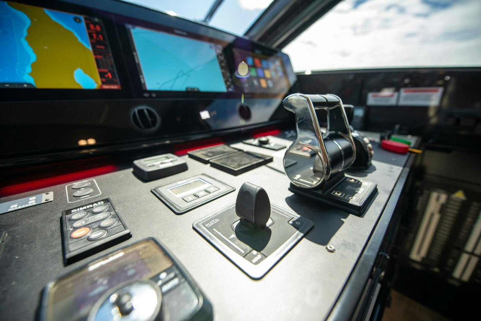 a table with a computer and other electronics on it aboard GIULIA Yacht for Sale