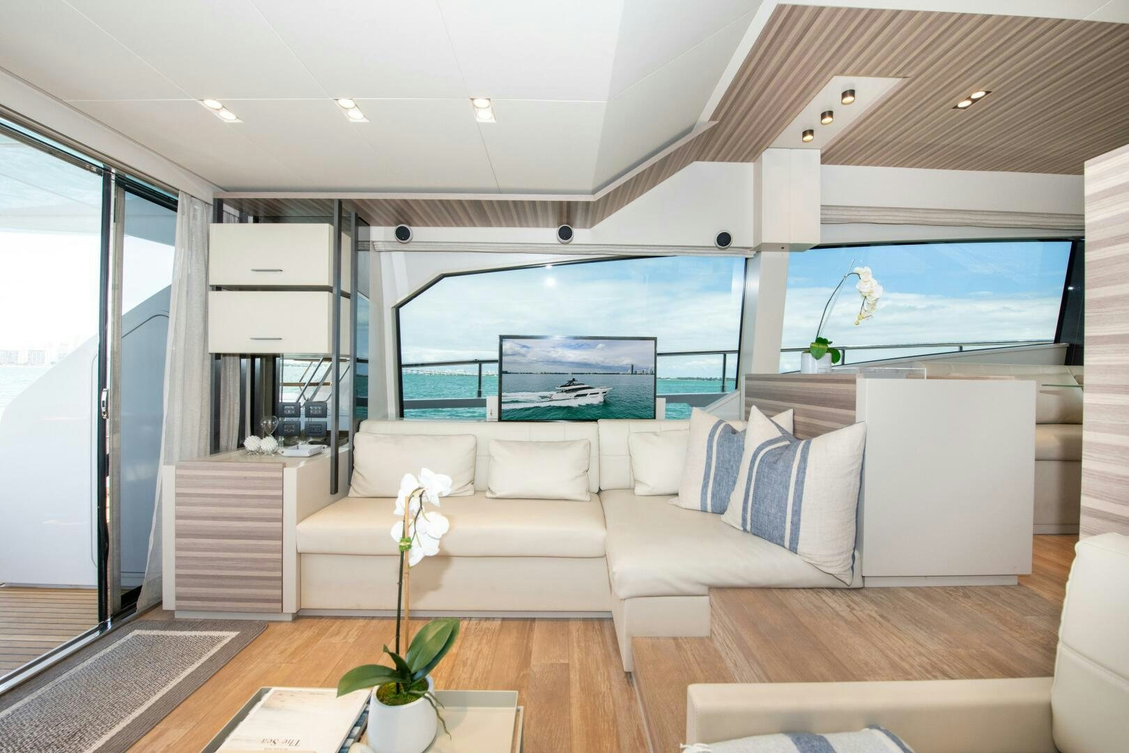 a living room with a large window aboard GIULIA Yacht for Sale