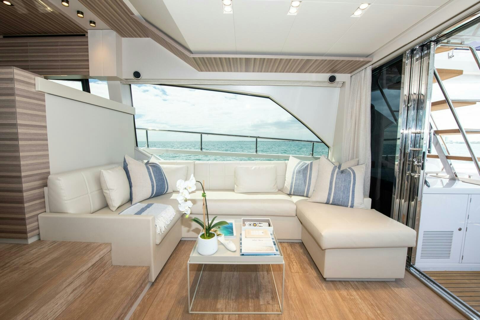 a living room with a large window aboard GIULIA Yacht for Sale