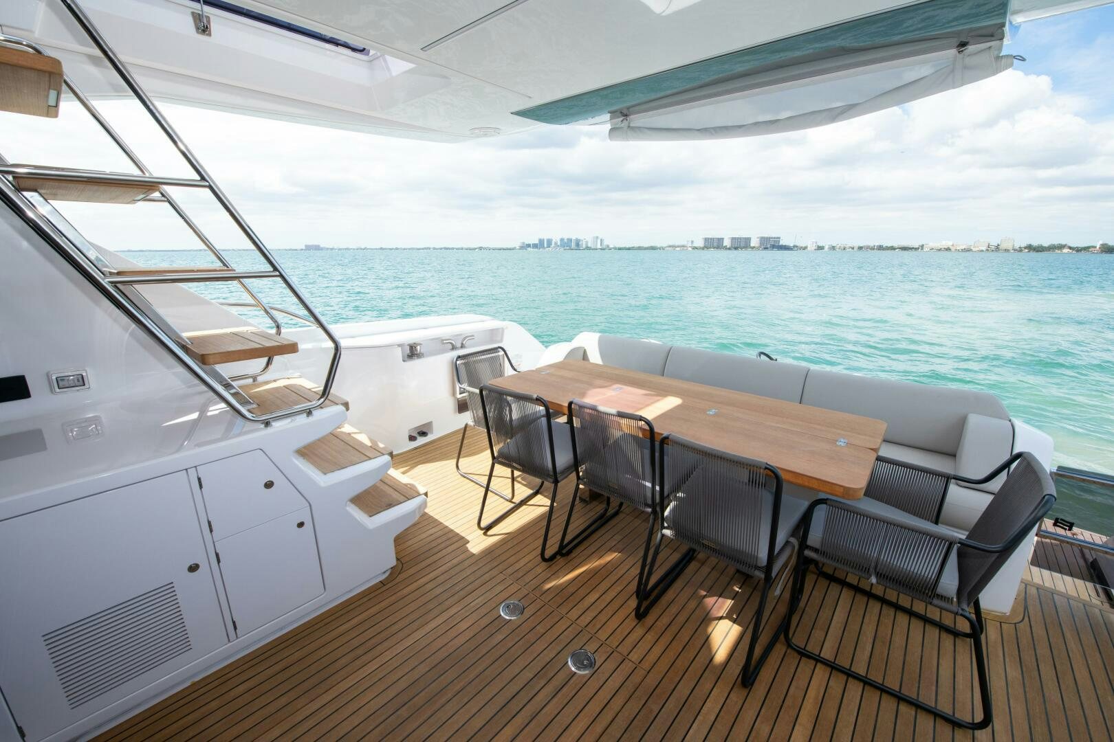 a deck with a table and chairs on it aboard GIULIA Yacht for Sale