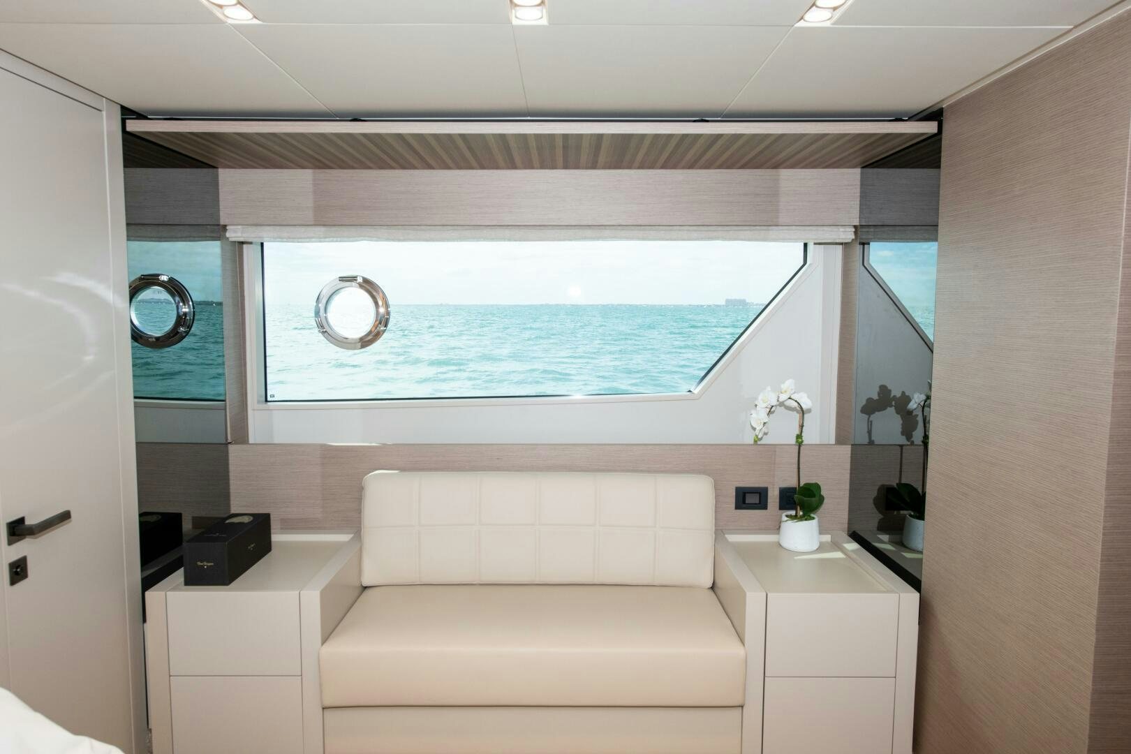 a room with a couch and a mirror aboard GIULIA Yacht for Sale