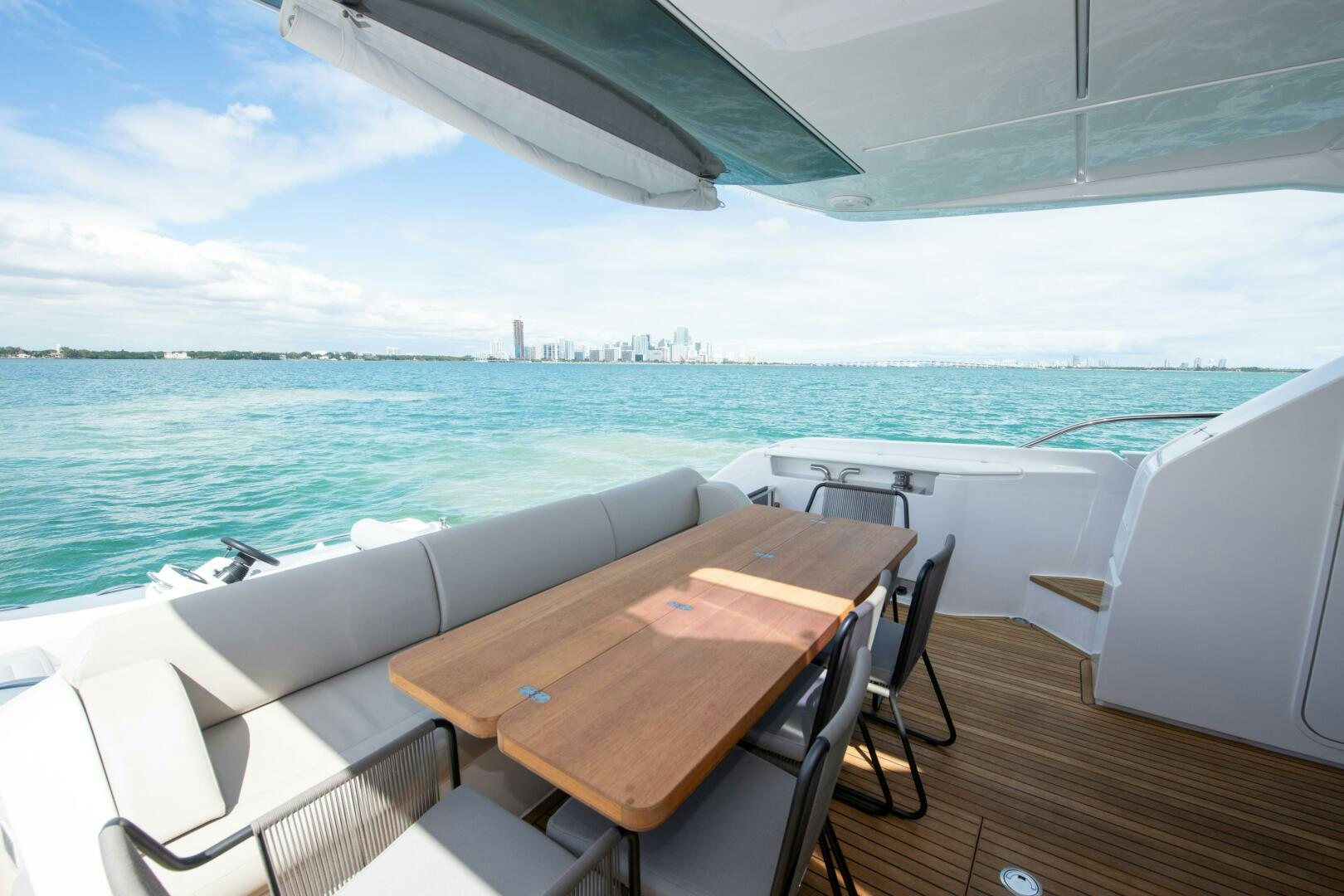 a table and chairs on a deck overlooking a large body of water aboard GIULIA Yacht for Sale
