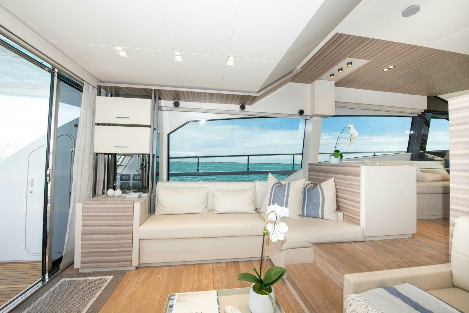 a living room with a large blue ocean aboard GIULIA Yacht for Sale