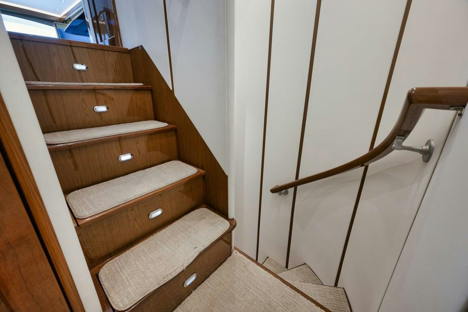 a wooden staircase with a wooden railing aboard SWEETUMS Yacht for Sale