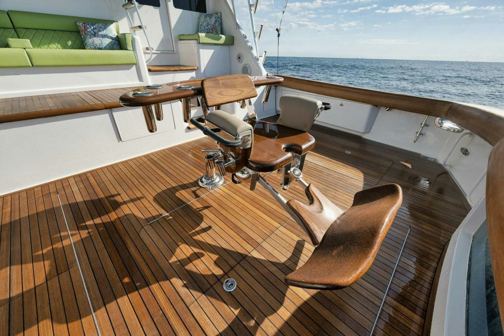 a deck with a table and chairs on it aboard SWEETUMS Yacht for Sale