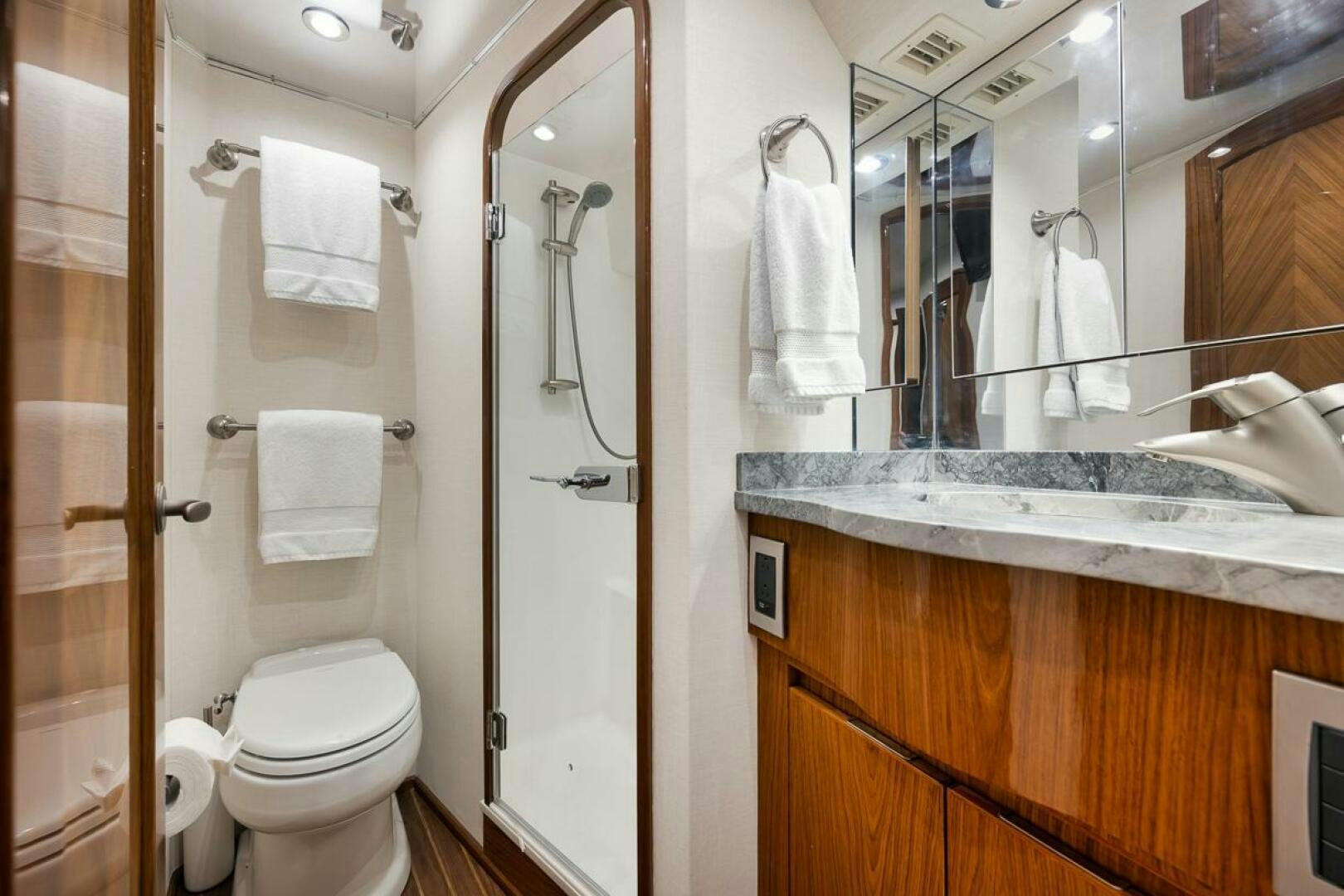 a bathroom with a toilet and a sink aboard SWEETUMS Yacht for Sale