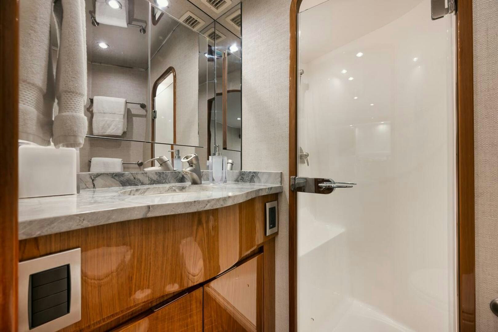 a bathroom with a sink and mirror aboard SWEETUMS Yacht for Sale