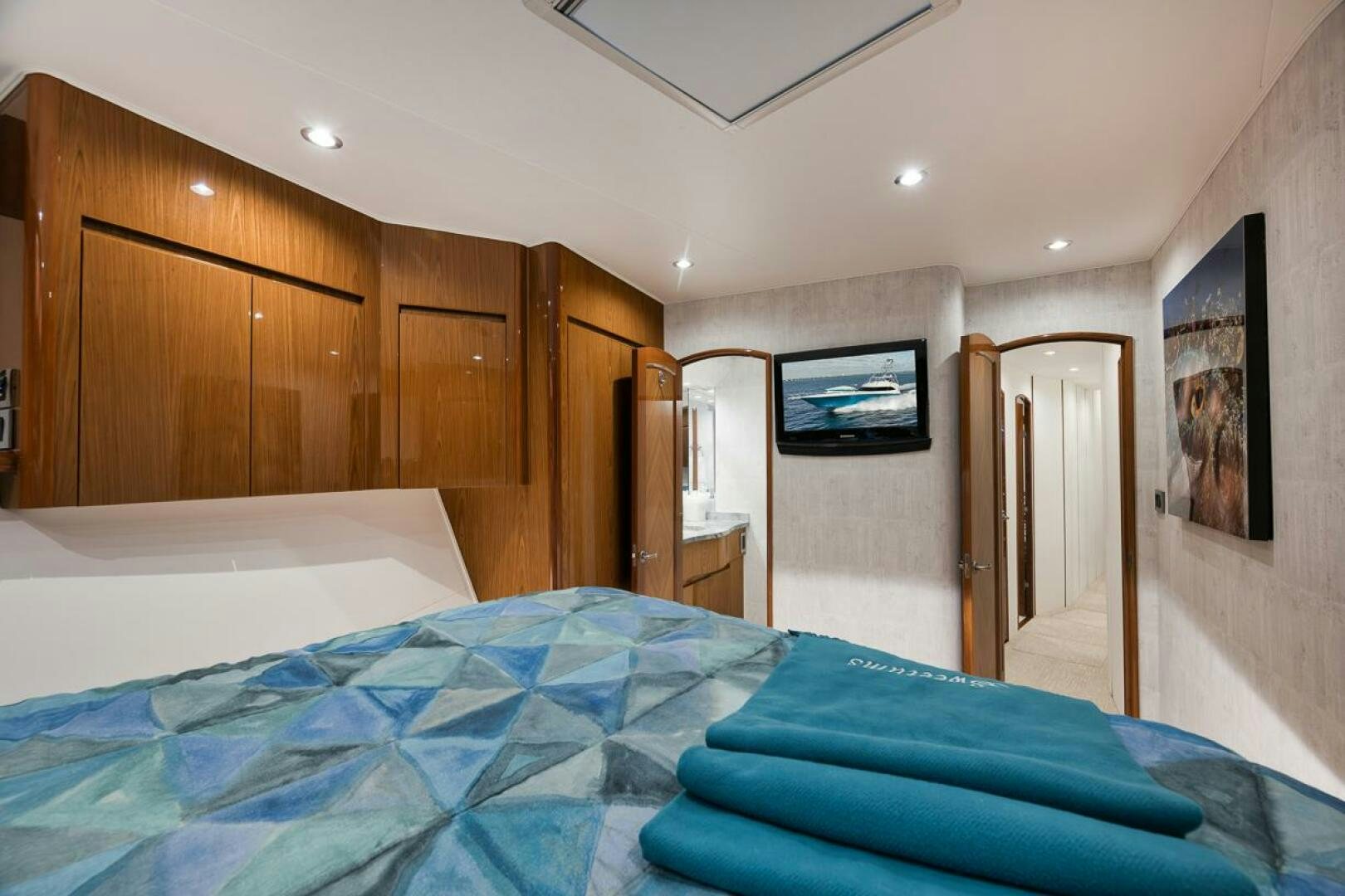 a bedroom with a bed and a television aboard SWEETUMS Yacht for Sale