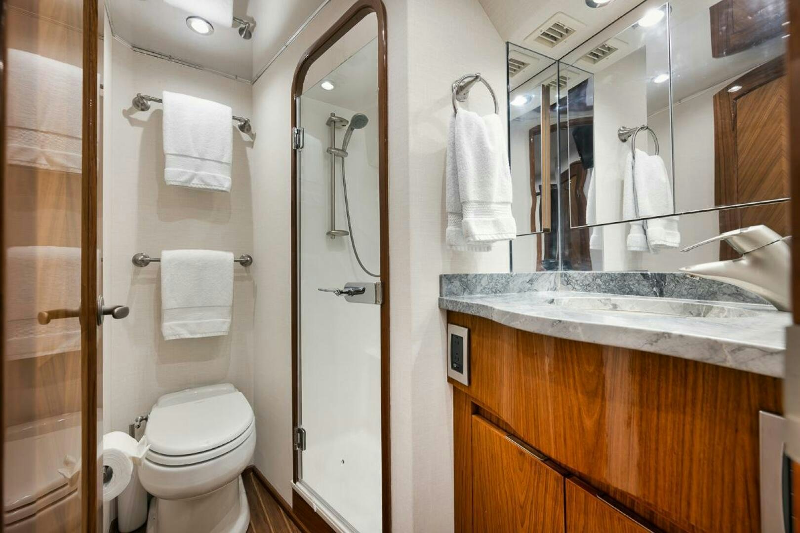 a bathroom with a toilet and a sink aboard SWEETUMS Yacht for Sale