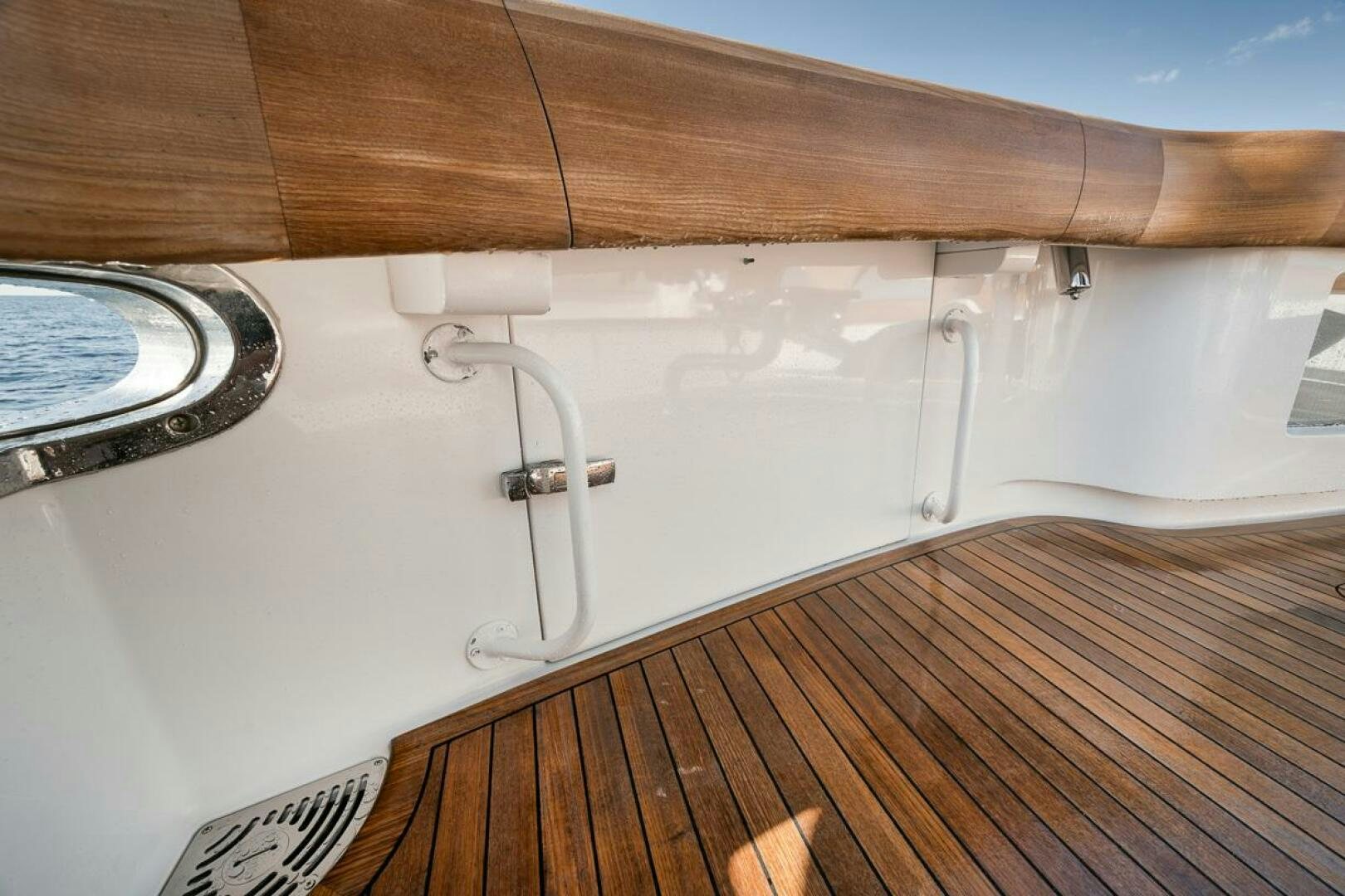 a wooden boat with a wooden railing aboard SWEETUMS Yacht for Sale