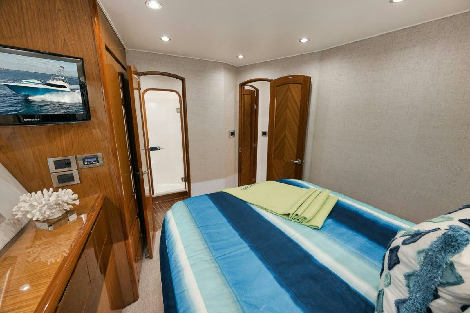 a bedroom with a television and a bed aboard SWEETUMS Yacht for Sale