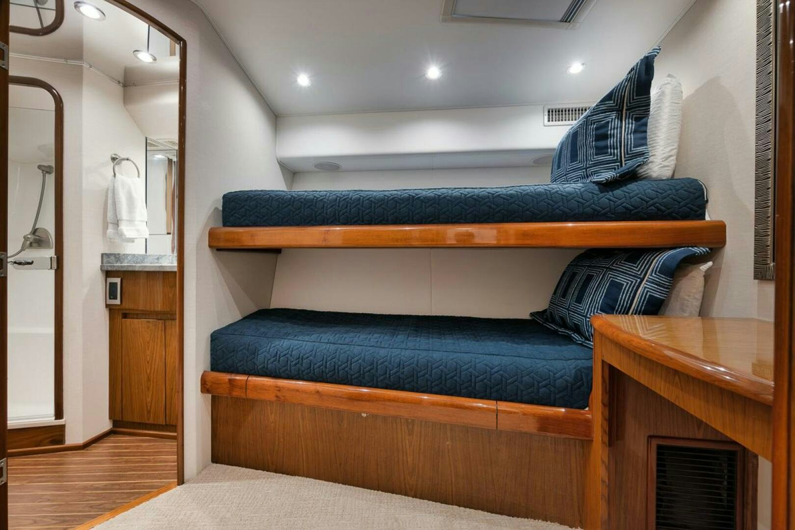 a couch with a blue pillow aboard SWEETUMS Yacht for Sale