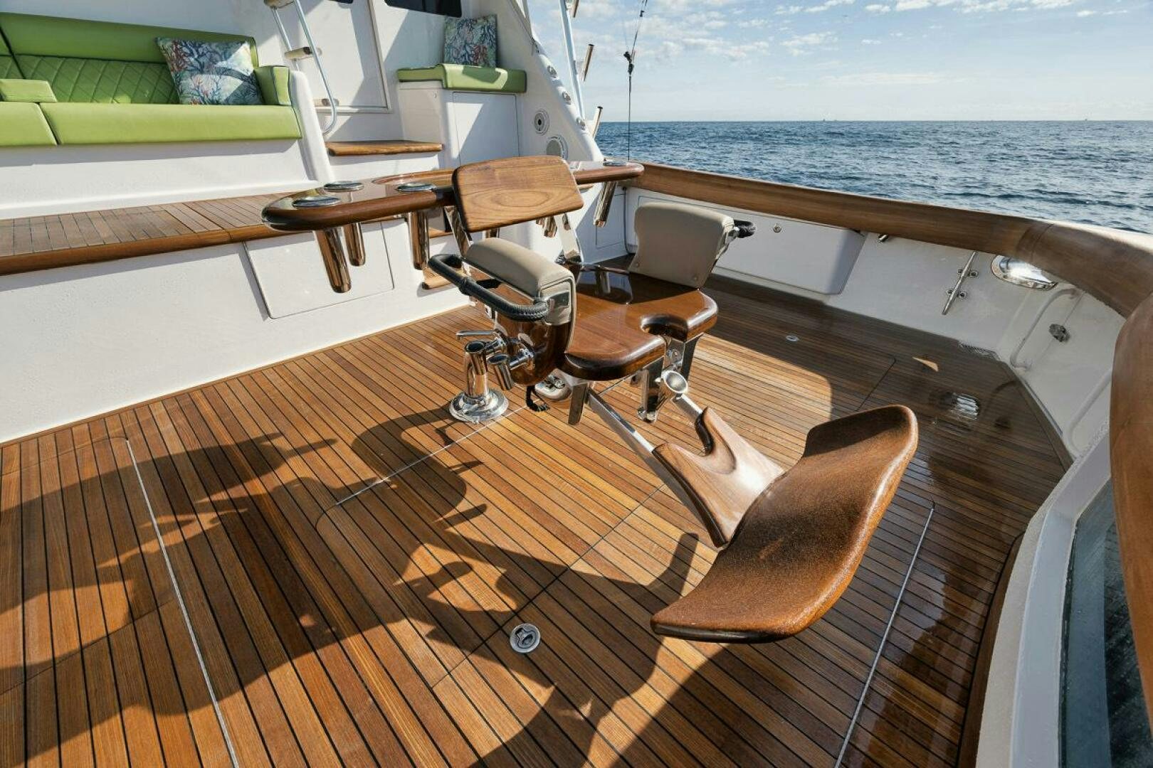 a deck with chairs and a table on it aboard SWEETUMS Yacht for Sale