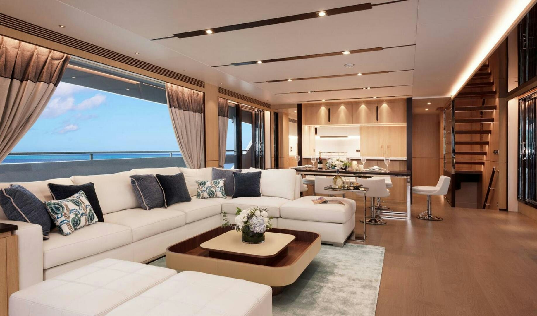 a living room with a couch and a table aboard ICE Yacht for Sale