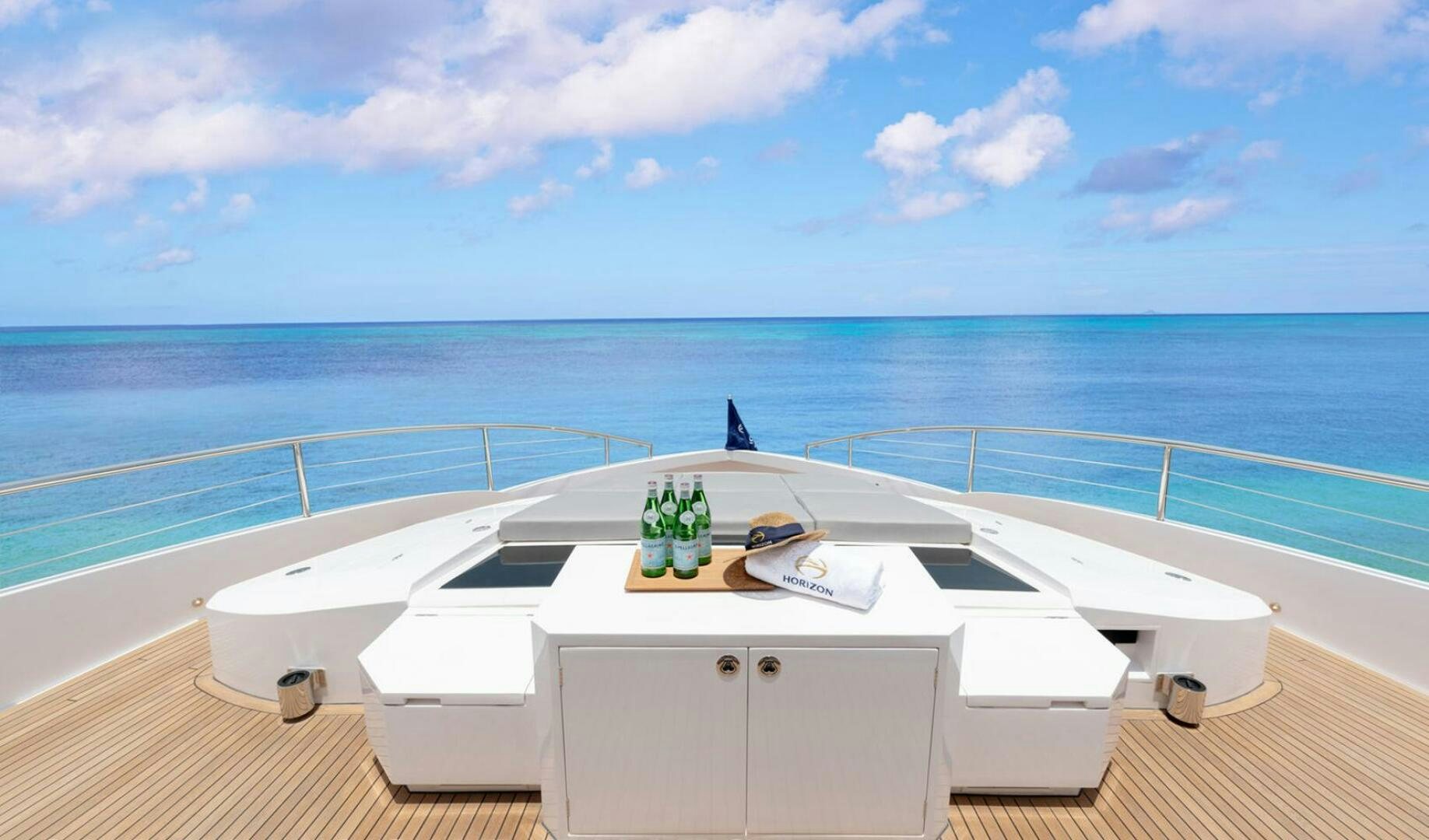 a white table on a deck overlooking the ocean aboard ICE Yacht for Sale