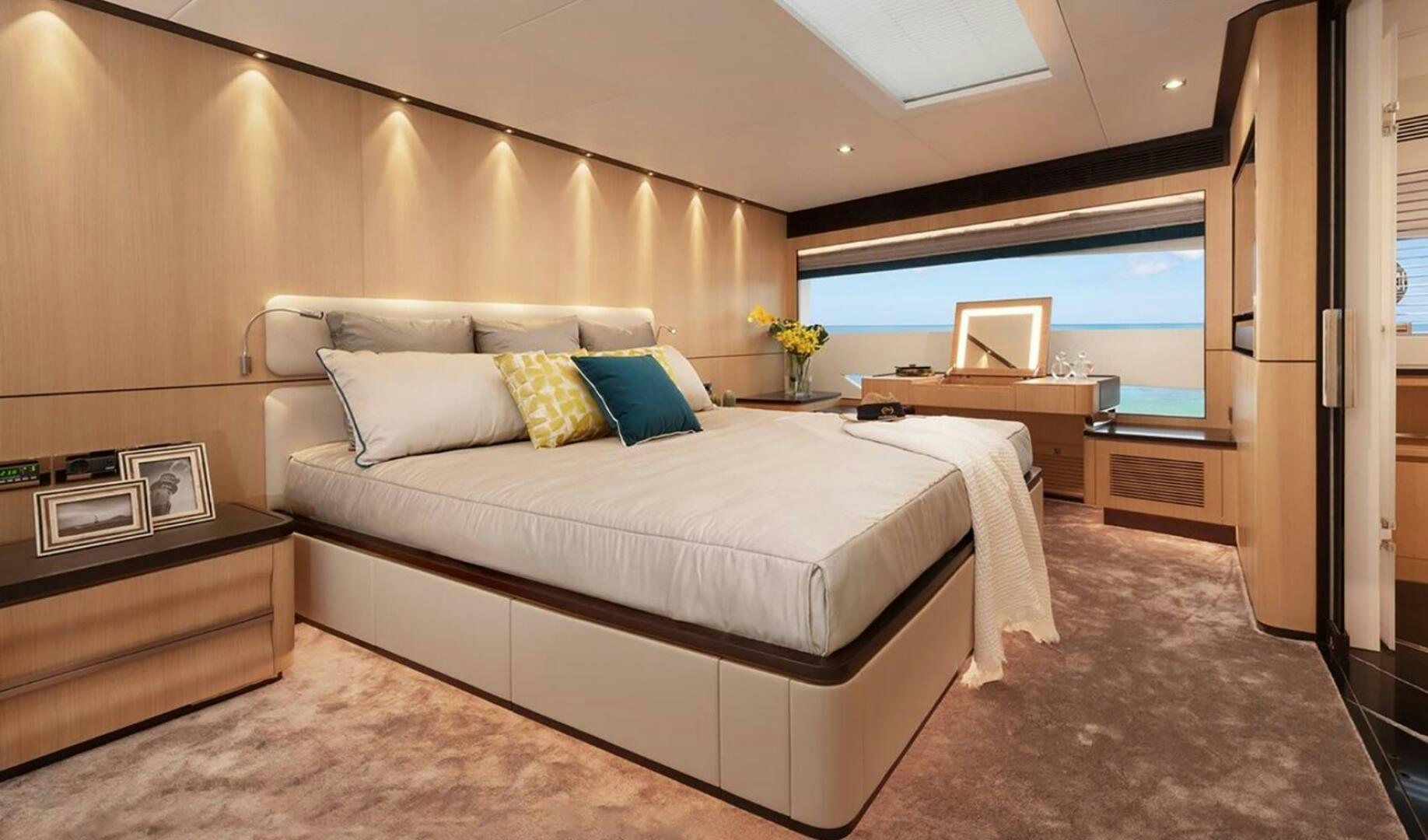 a room with a bed and a desk aboard ICE Yacht for Sale