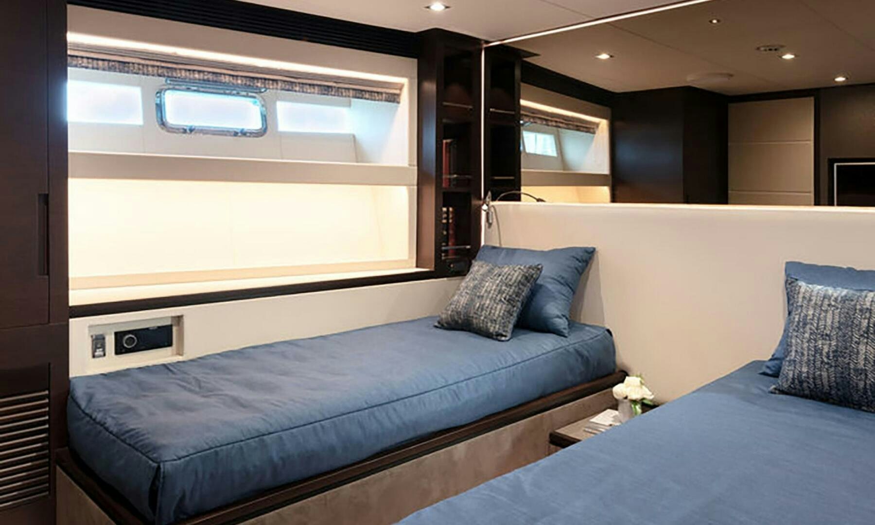 a room with a bed and a tv aboard ICE Yacht for Sale