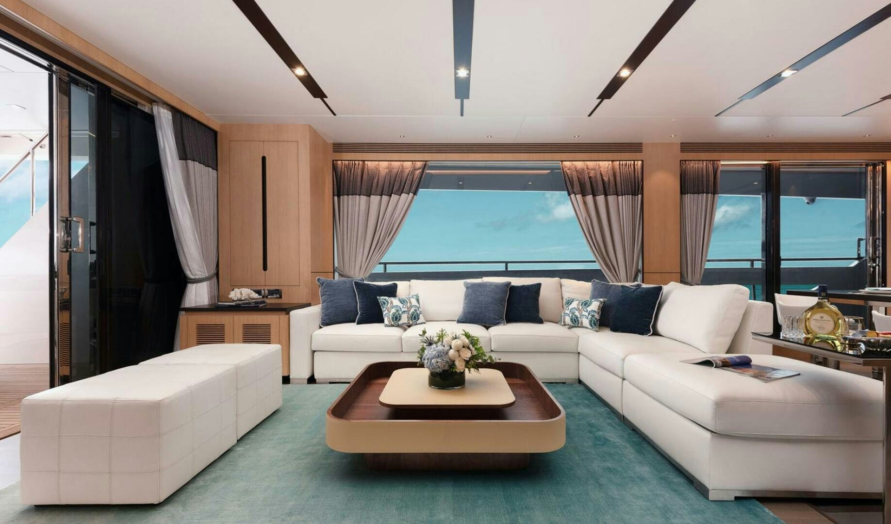 a living room with a couch and a table aboard ICE Yacht for Sale