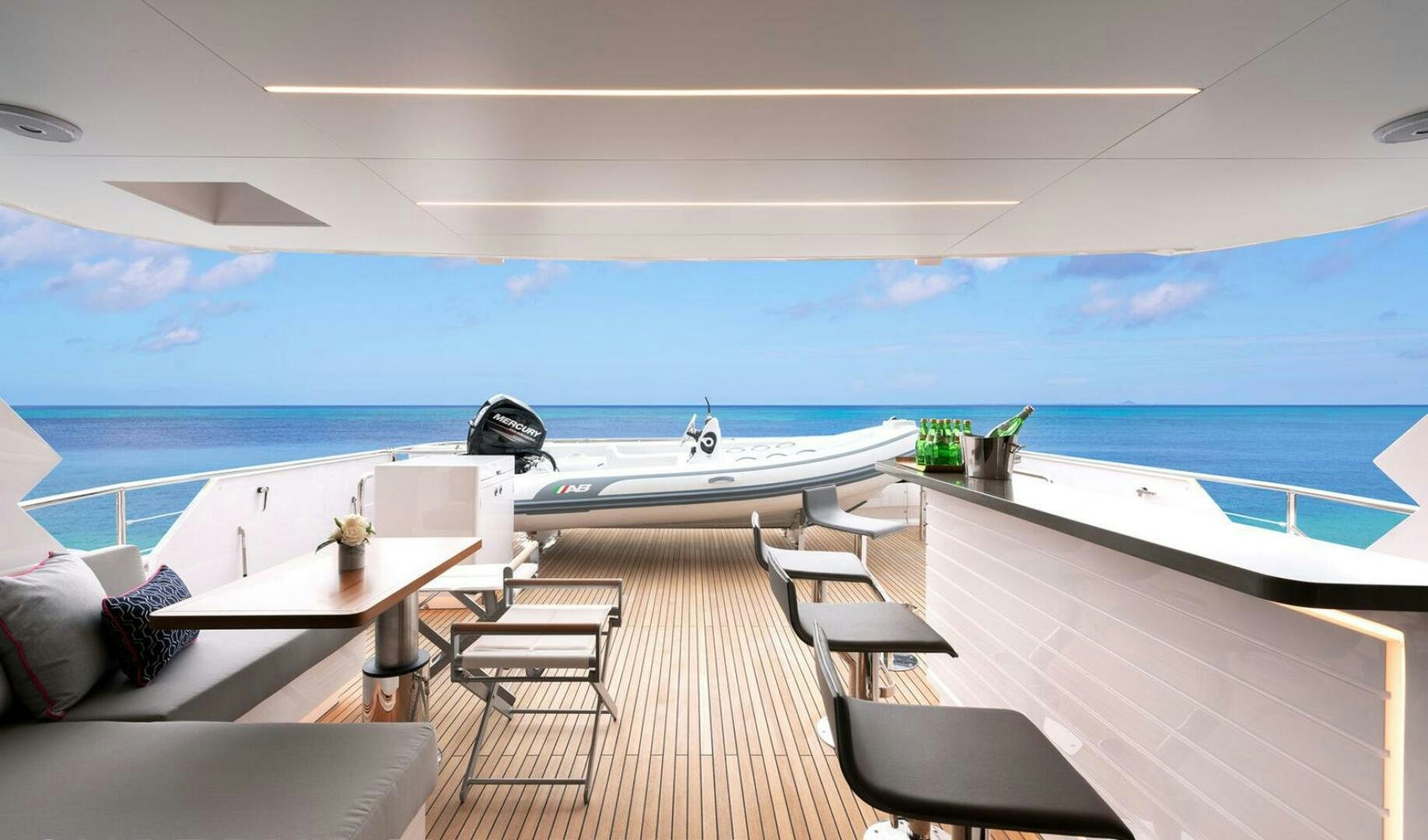 a room with a deck and chairs and a pool aboard ICE Yacht for Sale