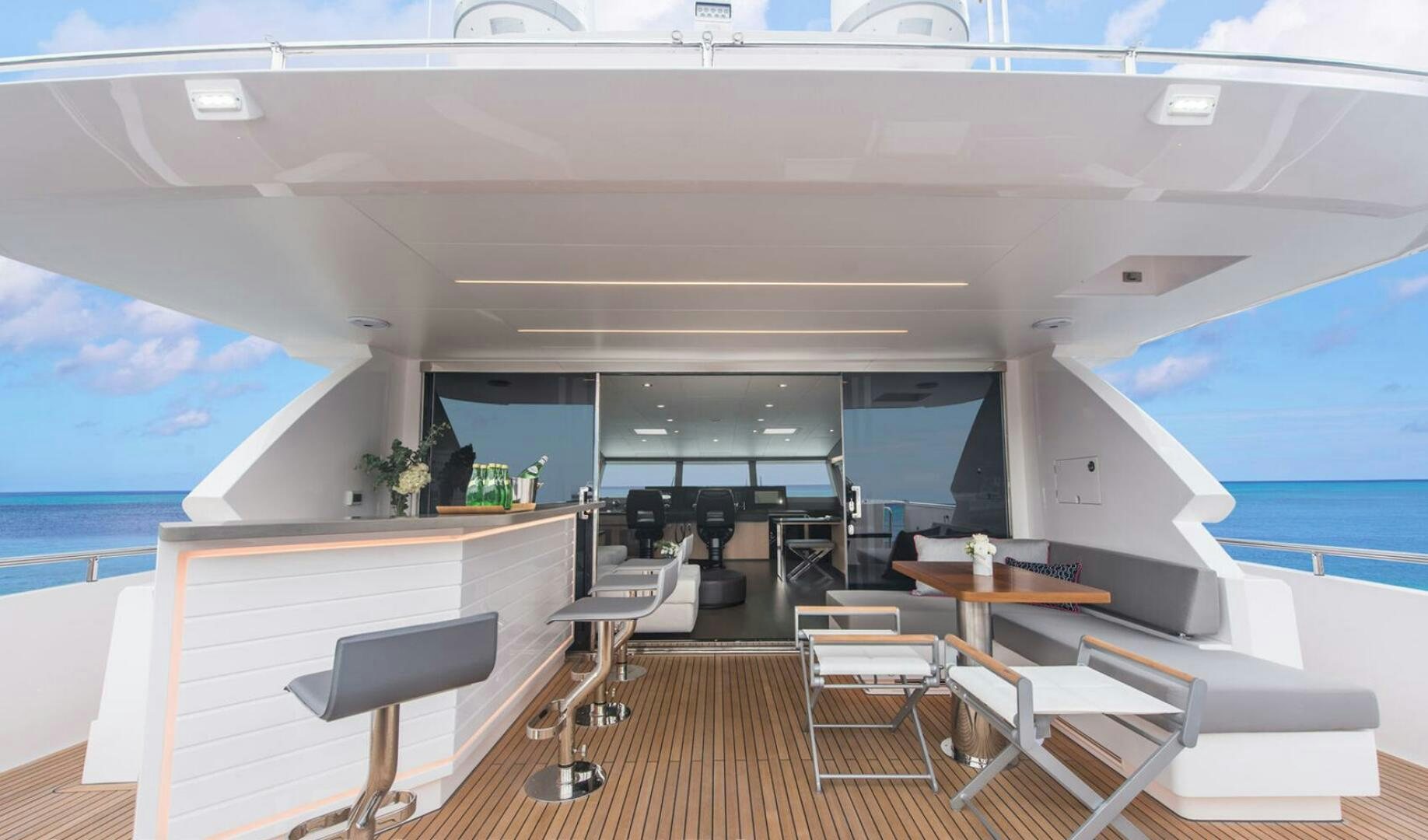 a room with tables and chairs aboard ICE Yacht for Sale