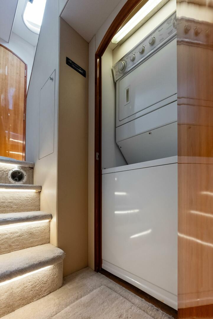 a white washer and dryer in a bathroom aboard TOUCH N GO Yacht for Sale