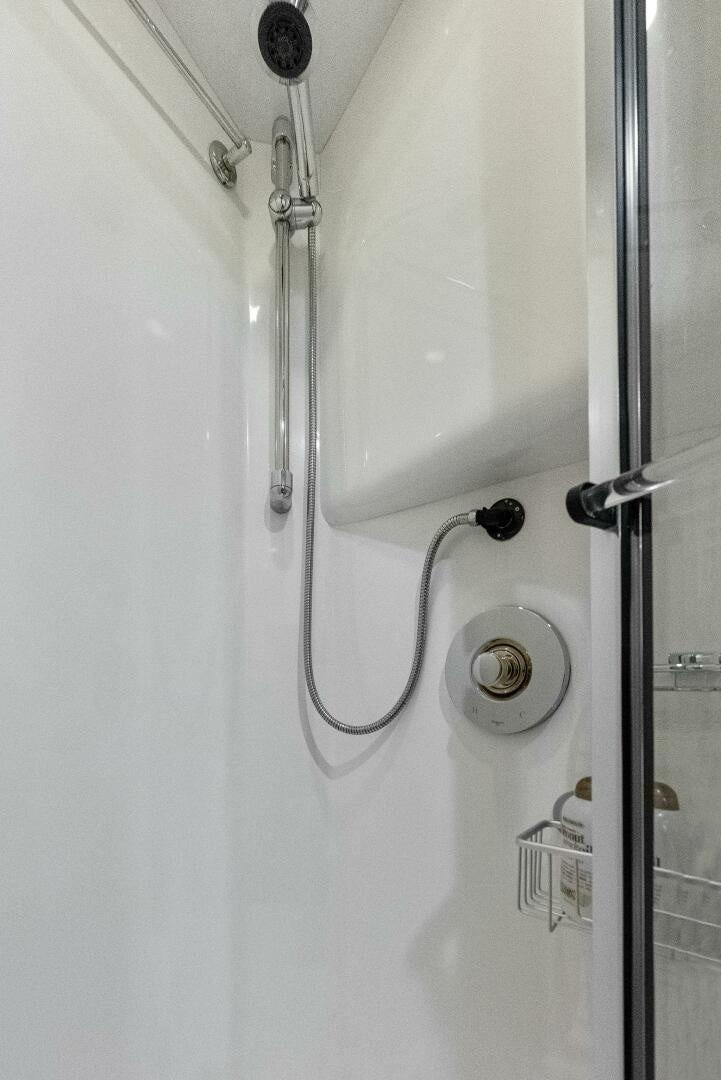 a white wall with a shower head aboard TOUCH N GO Yacht for Sale